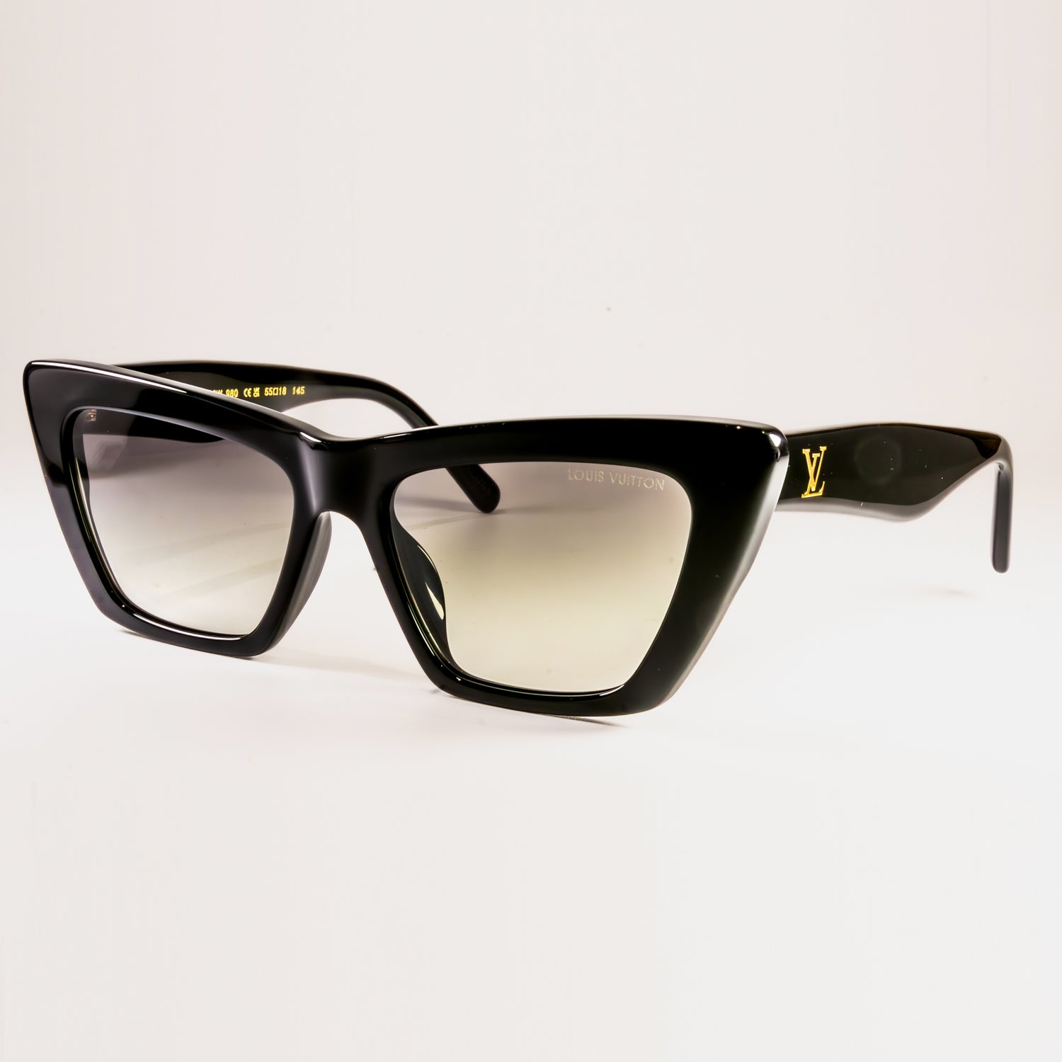 LV Fame Cat Eye Z1723W Sunglasses featuring a black acetate frame and green lenses with gold-toned LV details.