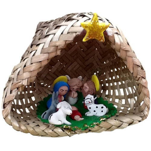 Handcrafted marzipan nativity set displayed in a woven palm basket, showcasing intricate details of each figurine.