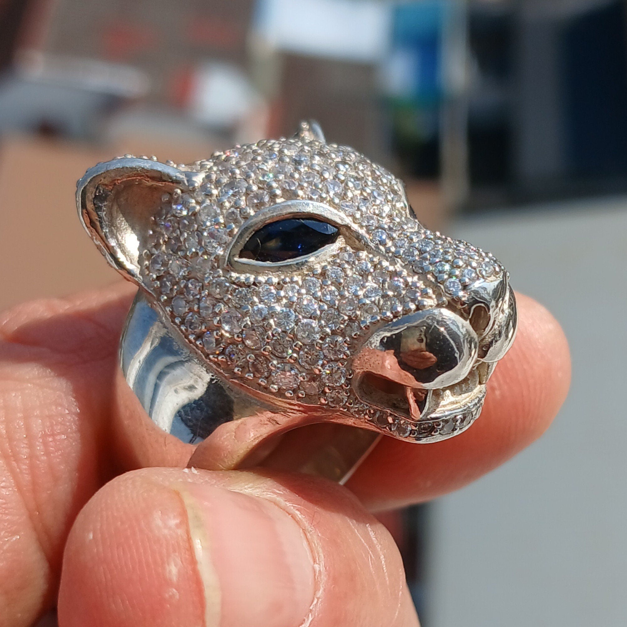 Men's Panther Ring in sterling silver with cubic zirconia stones and blue sapphire CZ eyes, showcasing intricate handcrafted design.