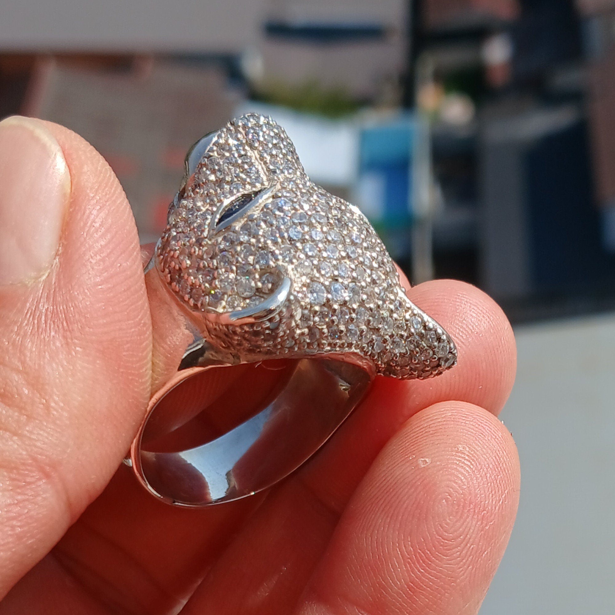 Men's Panther Ring in sterling silver with cubic zirconia stones and blue sapphire CZ eyes, showcasing intricate handcrafted design.