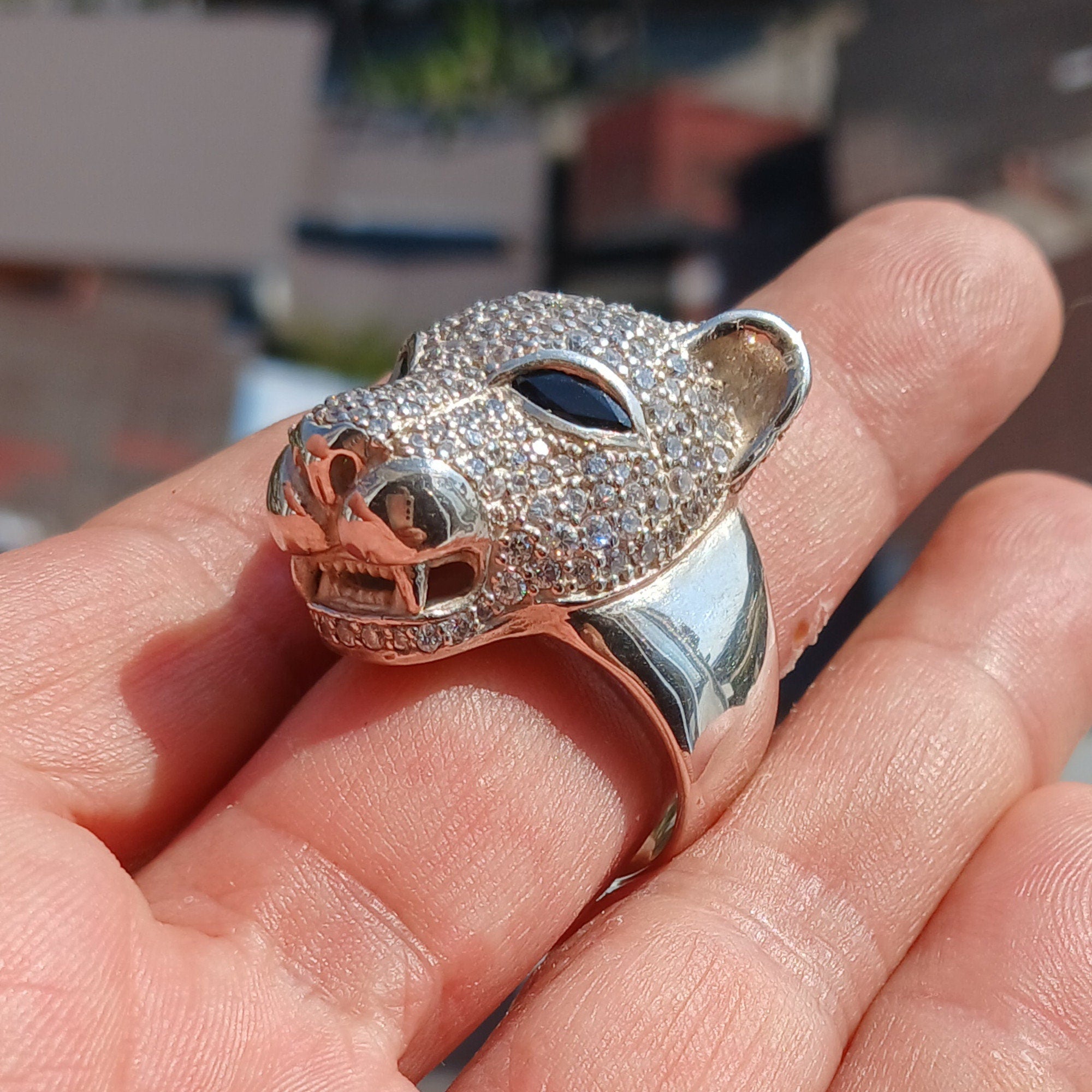 Men's Panther Ring in sterling silver with cubic zirconia stones and blue sapphire CZ eyes, showcasing intricate handcrafted design.
