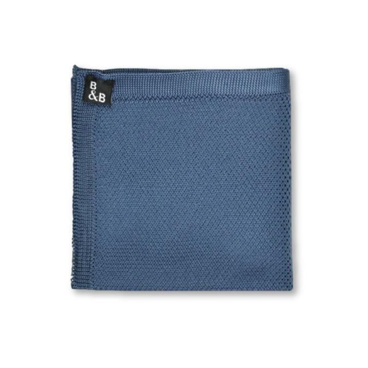 Midnight blue knitted pocket square displayed elegantly, showcasing its soft texture and rich color.