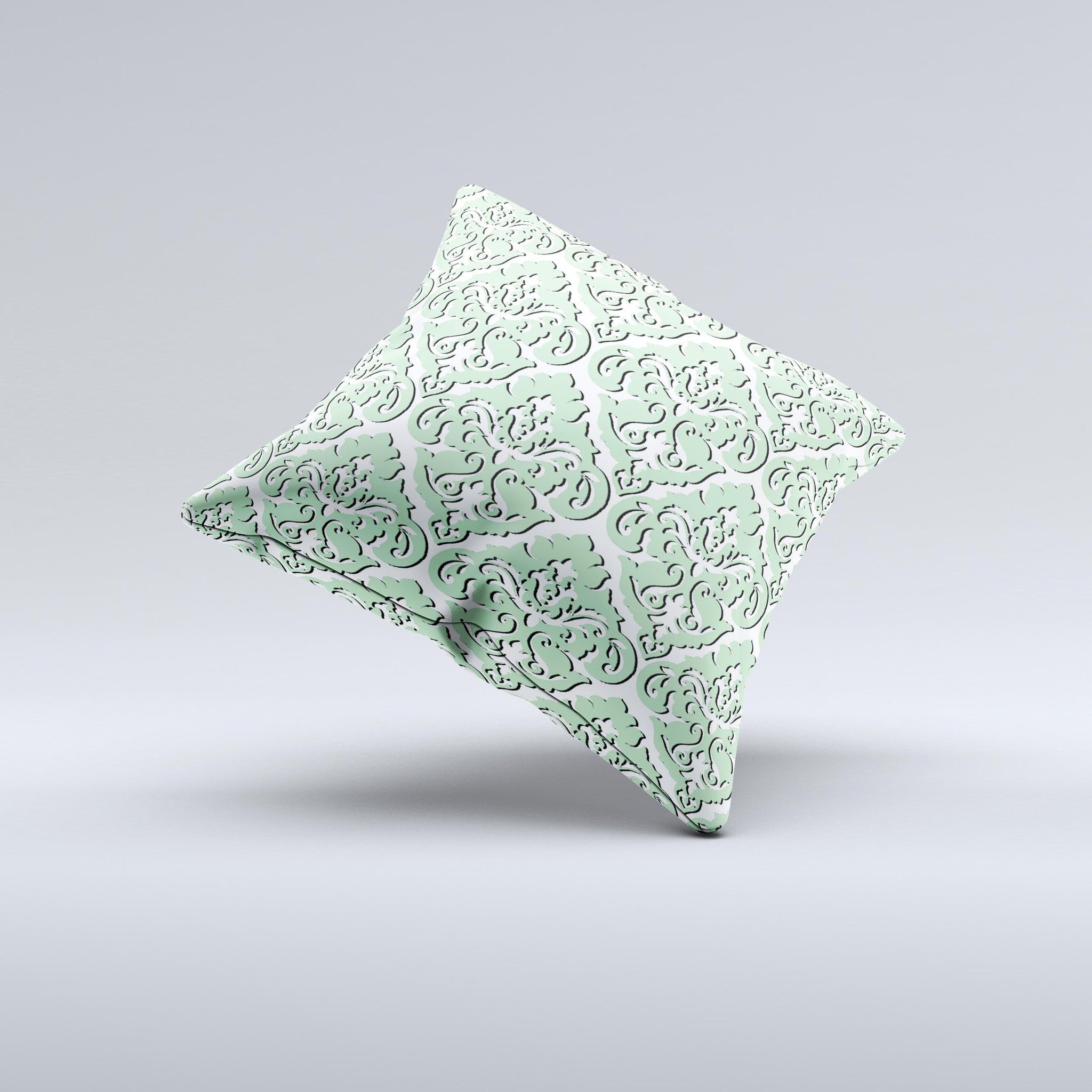 Mint and white decorative throw pillow with delicate pattern, handcrafted in Virginia, showcasing unique imperfections.