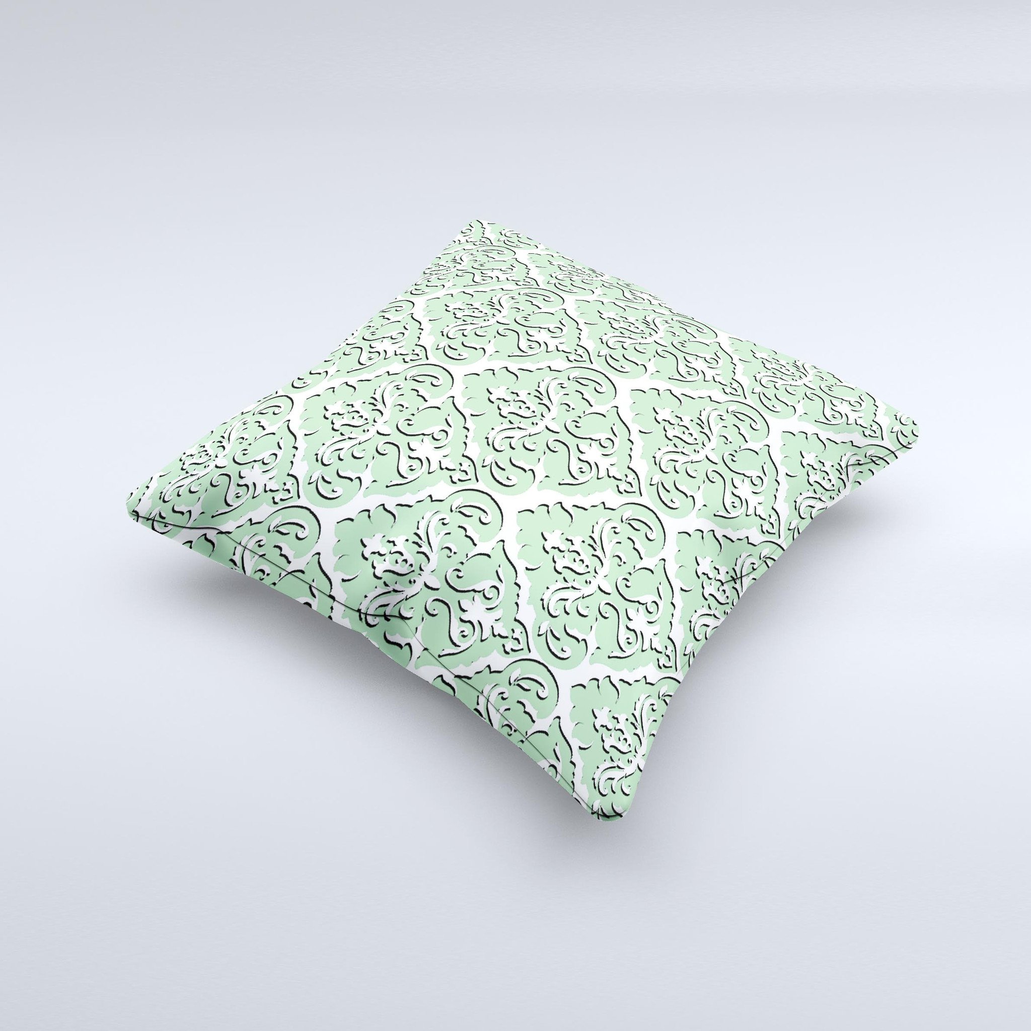 Mint and white decorative throw pillow with delicate pattern, handcrafted in Virginia, showcasing unique imperfections.