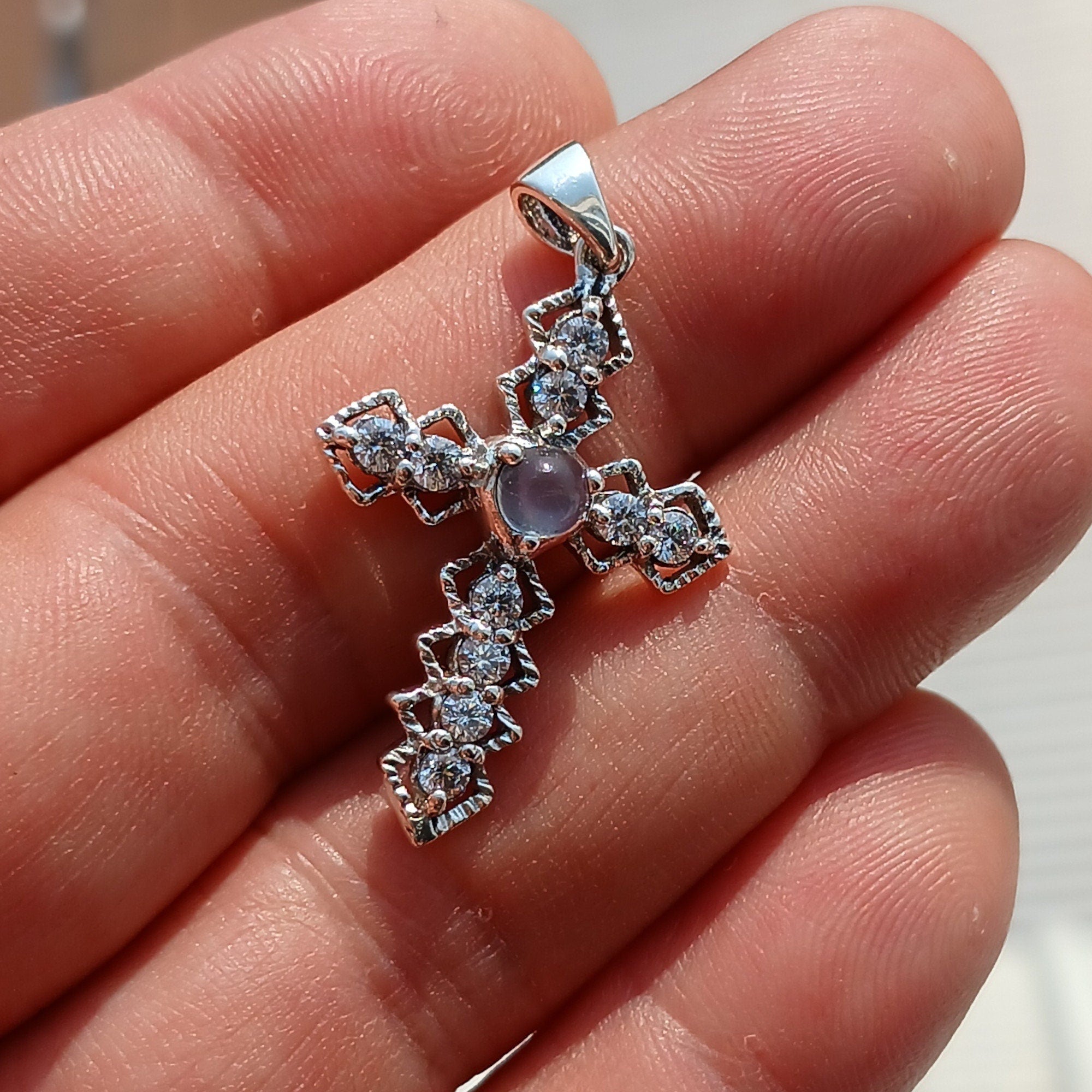 Moonstone Crucifix Sterling Silver Pendant featuring a round Ceylon Moonstone and sparkling CZ stones, elegantly designed.