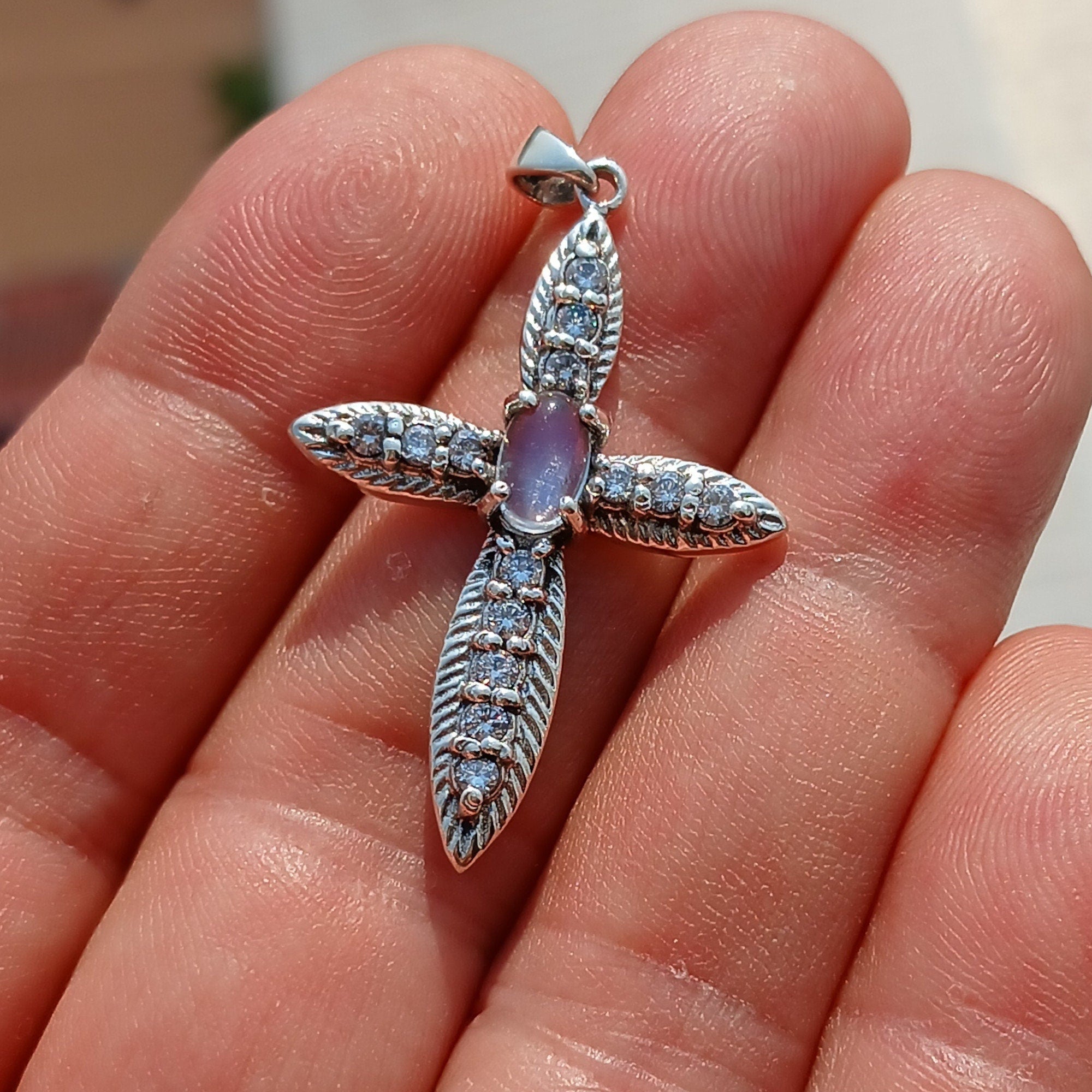 Moonstone Crucifix Sterling Silver Pendant featuring an oval Ceylon Moonstone and 14 sparkling CZ stones, elegantly designed.