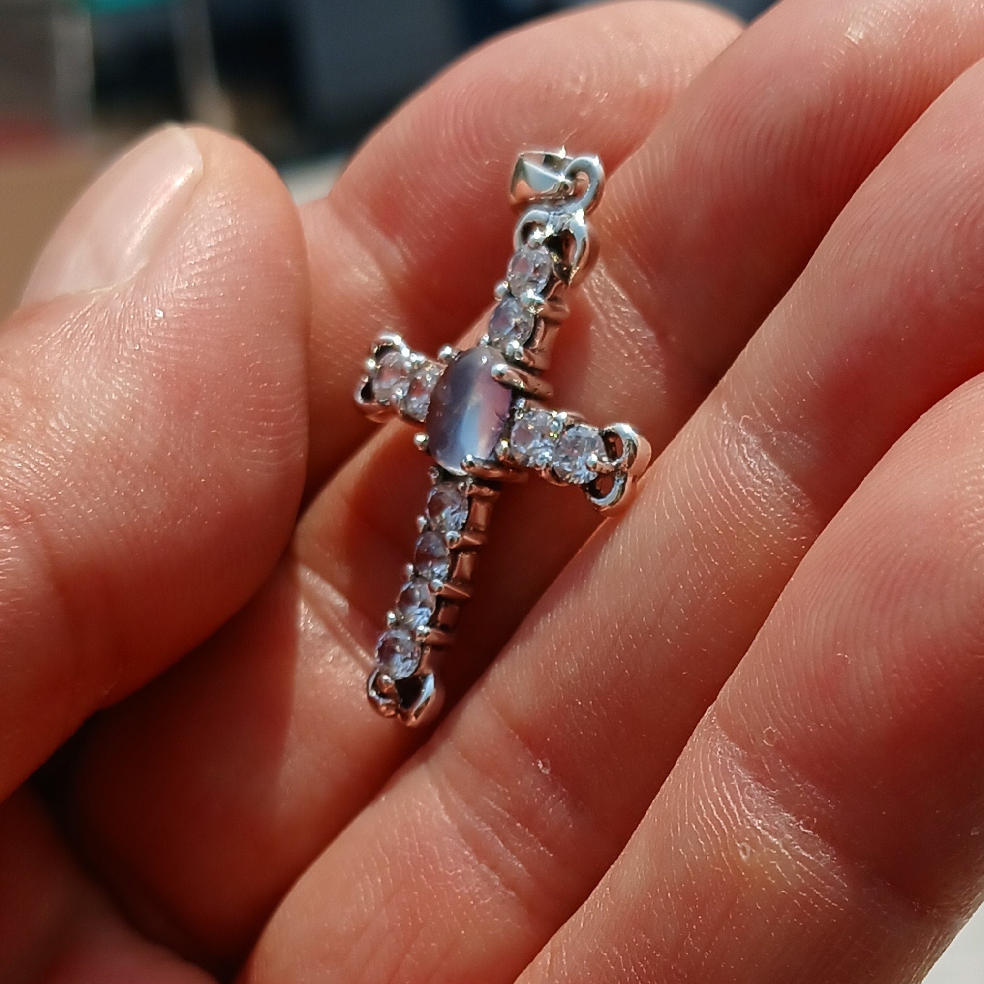 Moonstone Crucifix Sterling Silver Pendant featuring an oval Ceylon Moonstone and cubic zirconia stones, elegantly designed as a cross amulet.