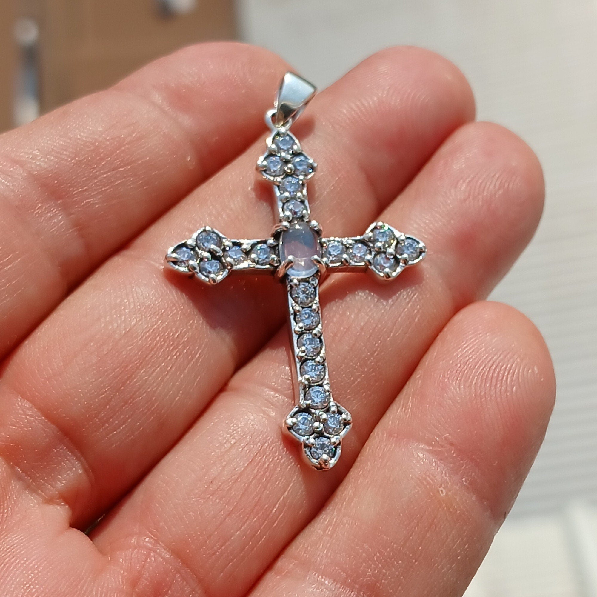Moonstone Crucifix pendant in sterling silver featuring a central Ceylon moonstone surrounded by cubic zirconia stones, elegantly designed.