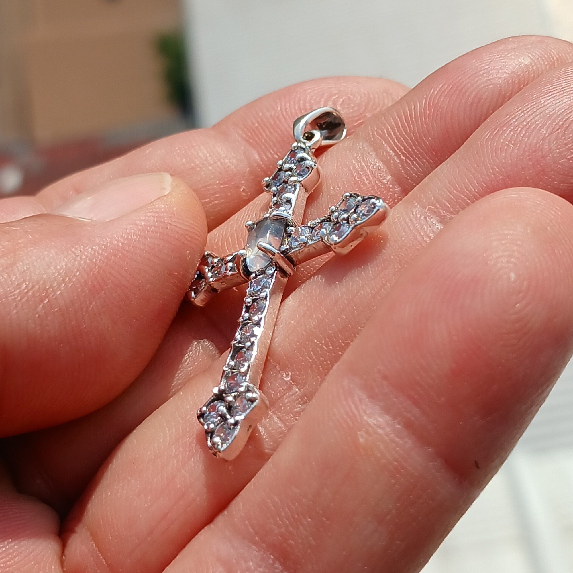 Moonstone Crucifix pendant in sterling silver featuring a central Ceylon moonstone surrounded by cubic zirconia stones, elegantly designed.