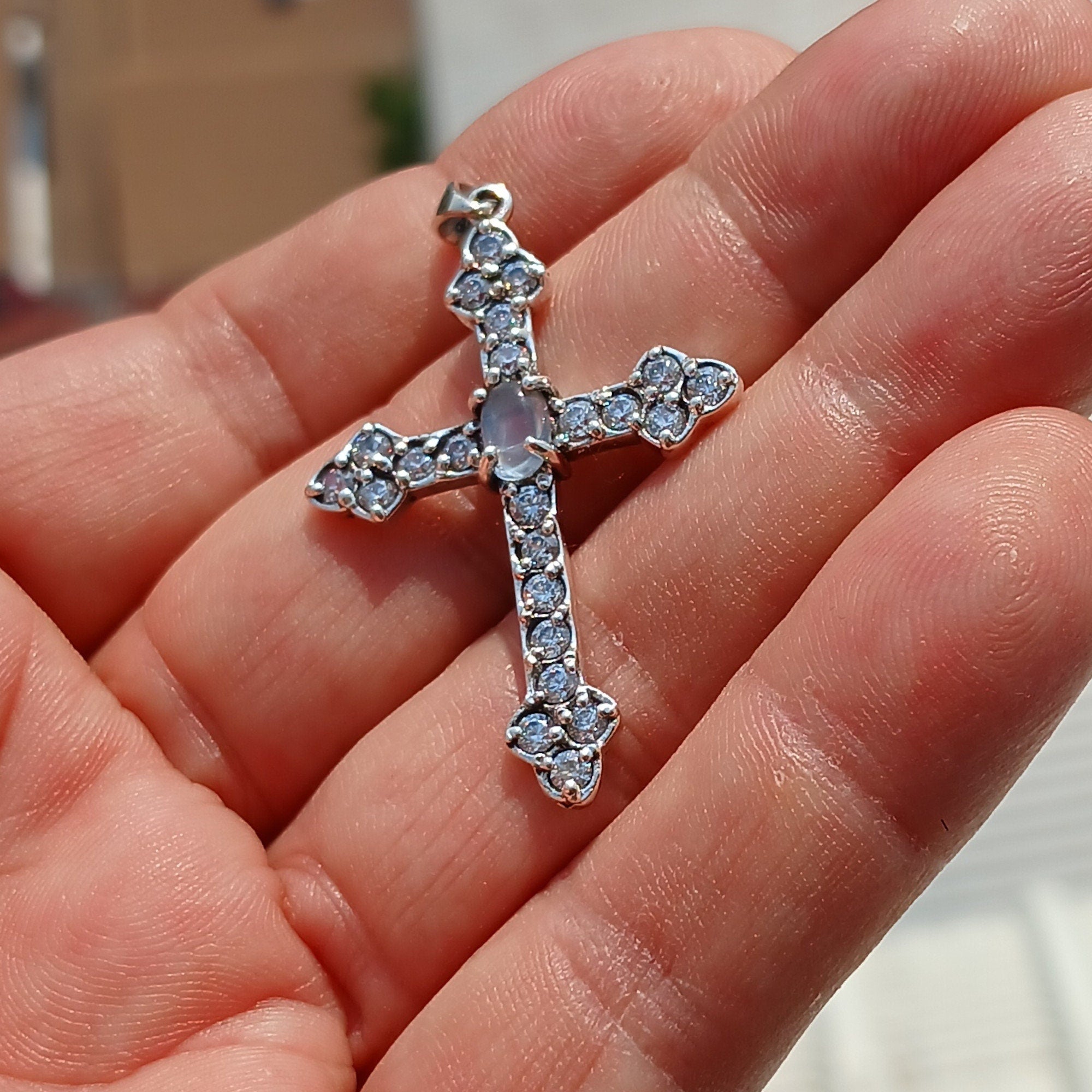 Moonstone Crucifix pendant in sterling silver featuring a central Ceylon moonstone surrounded by cubic zirconia stones, elegantly designed.