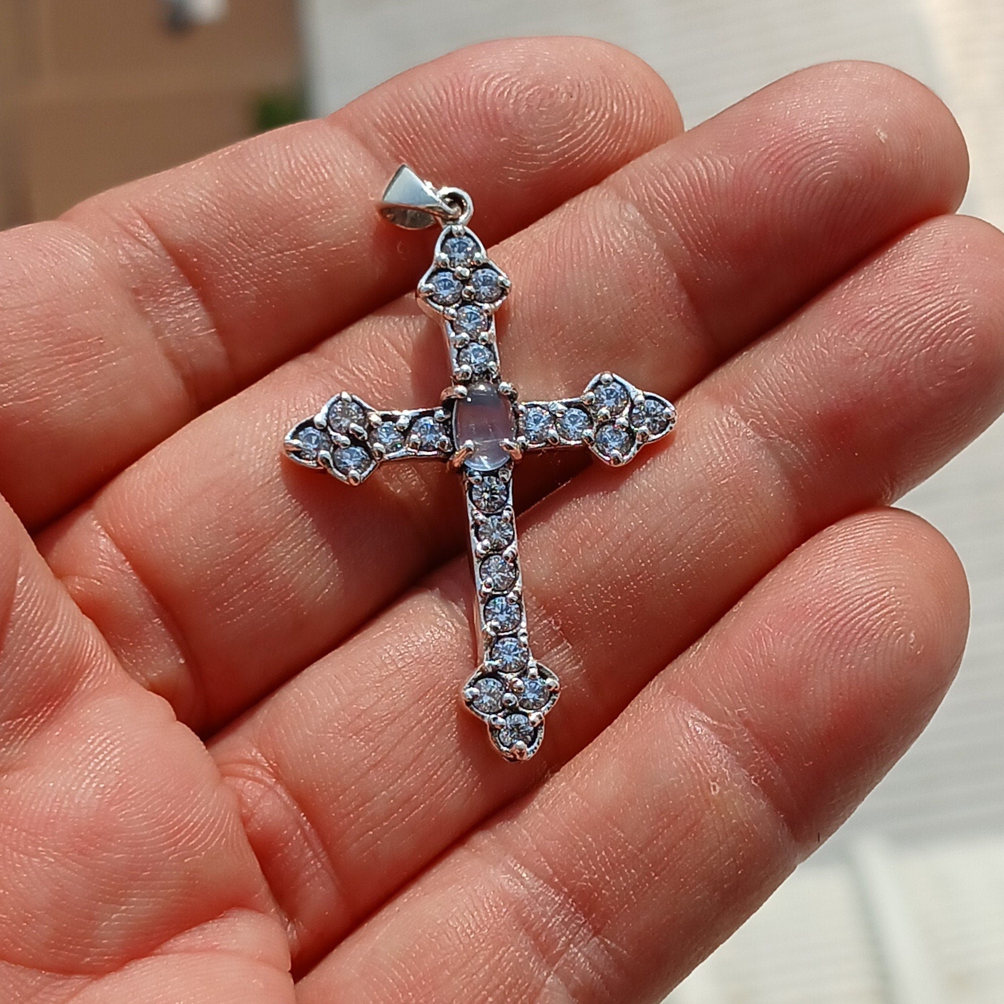 Moonstone Crucifix pendant in sterling silver featuring a central Ceylon moonstone surrounded by cubic zirconia stones, elegantly designed.