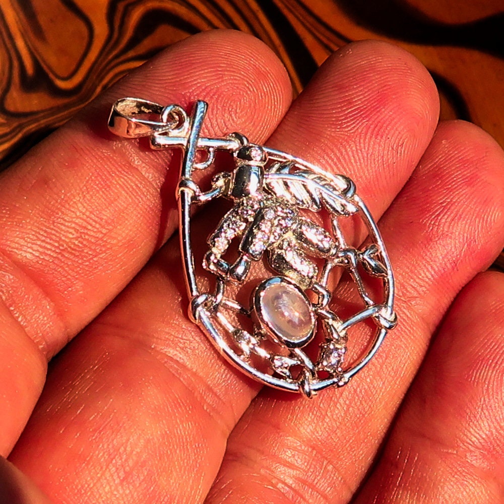 A beautiful Moonstone Pendant crafted in 925 sterling silver featuring a dream catcher design, adorned with cubic zirconia stones.