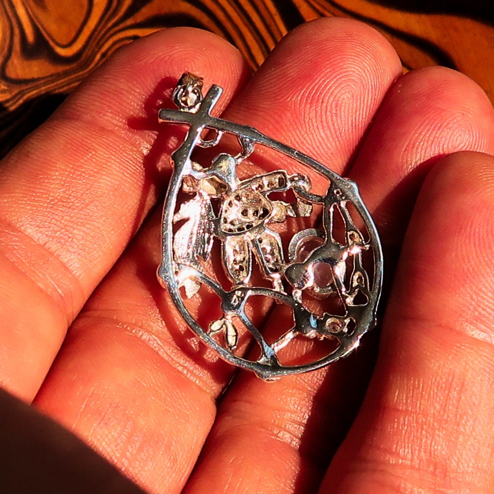 A beautiful Moonstone Pendant crafted in 925 sterling silver featuring a dream catcher design, adorned with cubic zirconia stones.