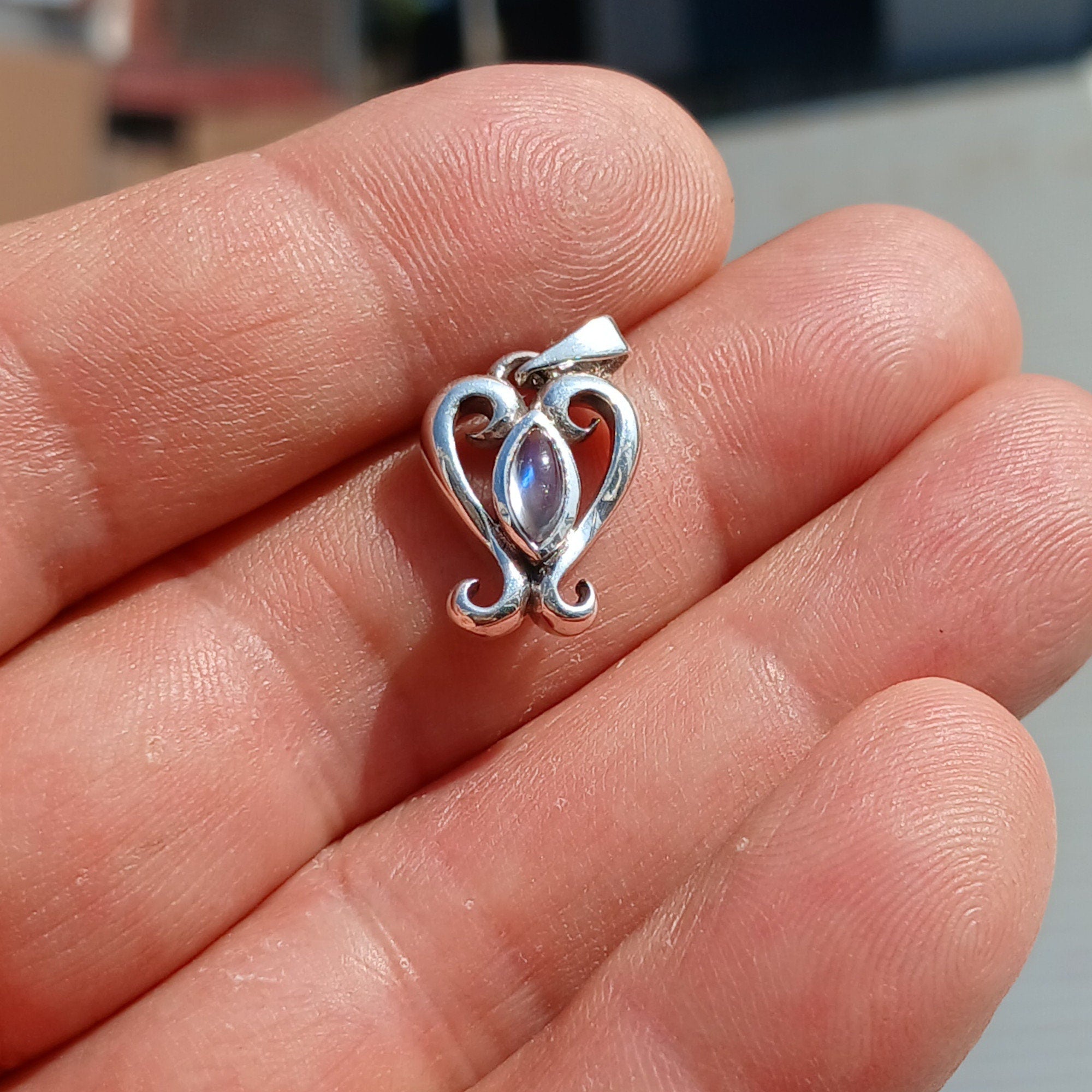 A beautiful heart-shaped Moonstone Pendant crafted from 925 Sterling Silver, featuring a marquise Ceylon Moonstone cabochon.