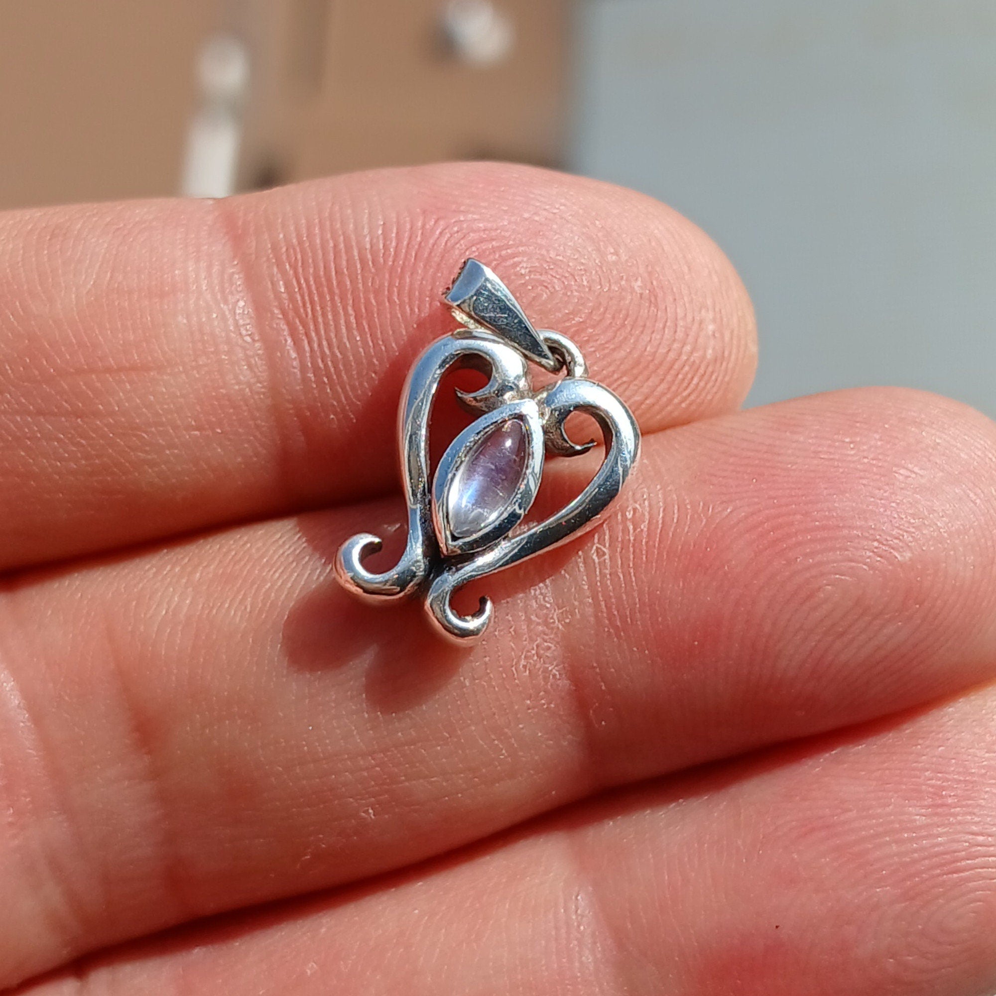 A beautiful heart-shaped Moonstone Pendant crafted from 925 Sterling Silver, featuring a marquise Ceylon Moonstone cabochon.