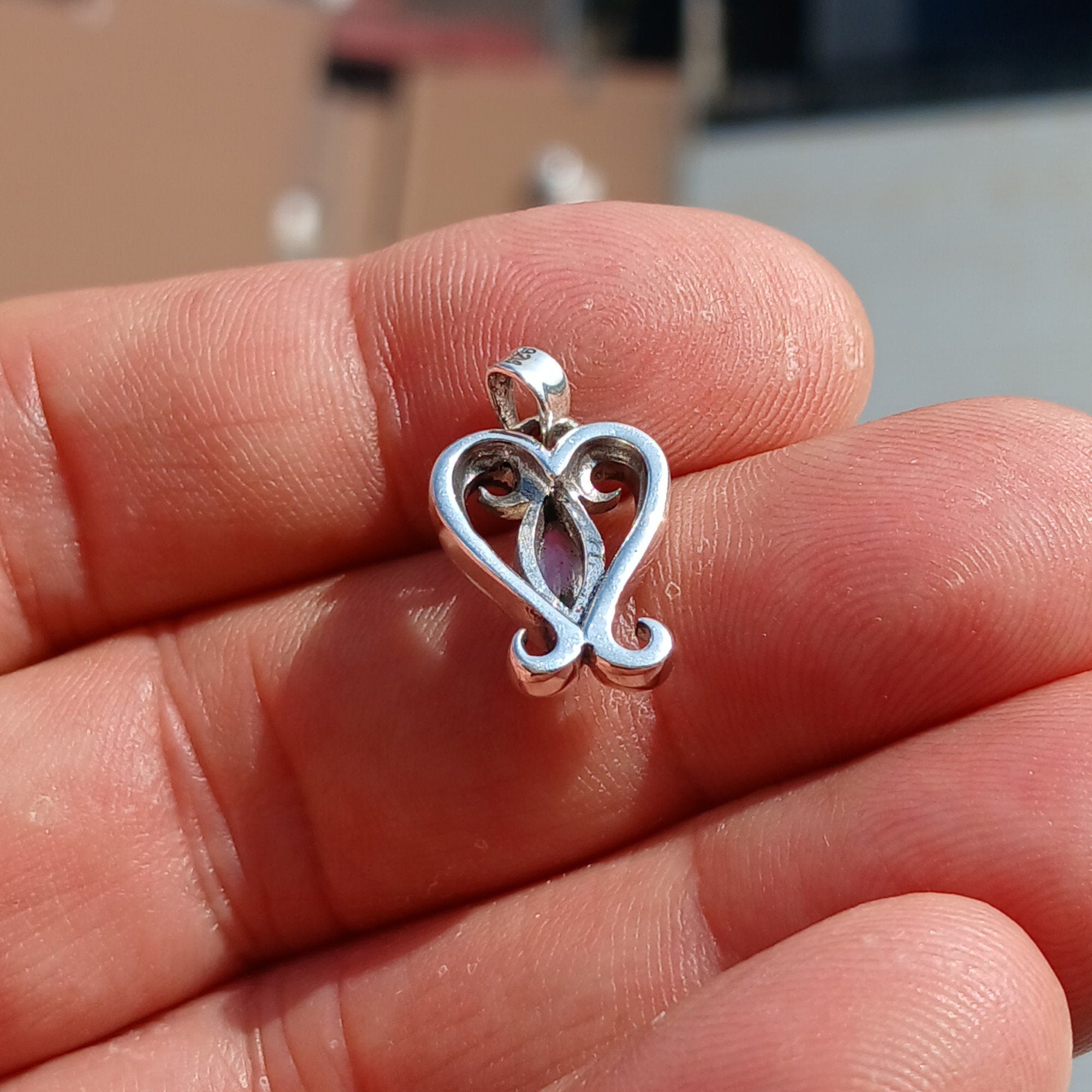 A beautiful heart-shaped Moonstone Pendant crafted from 925 Sterling Silver, featuring a marquise Ceylon Moonstone cabochon.