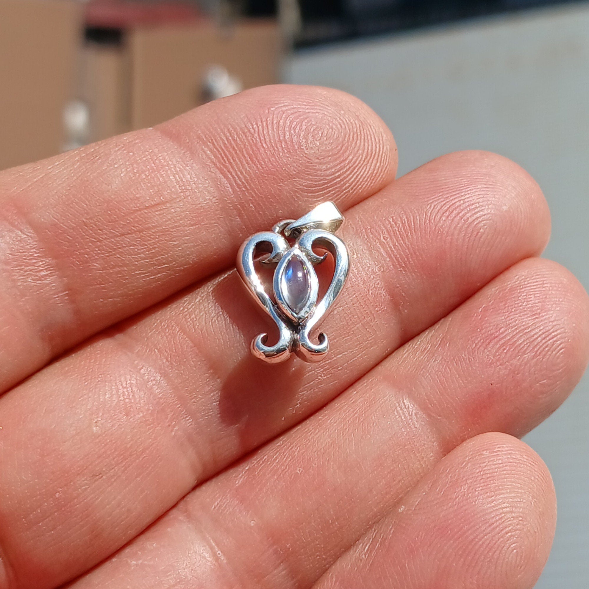 A beautiful heart-shaped Moonstone Pendant crafted from 925 Sterling Silver, featuring a marquise Ceylon Moonstone cabochon.