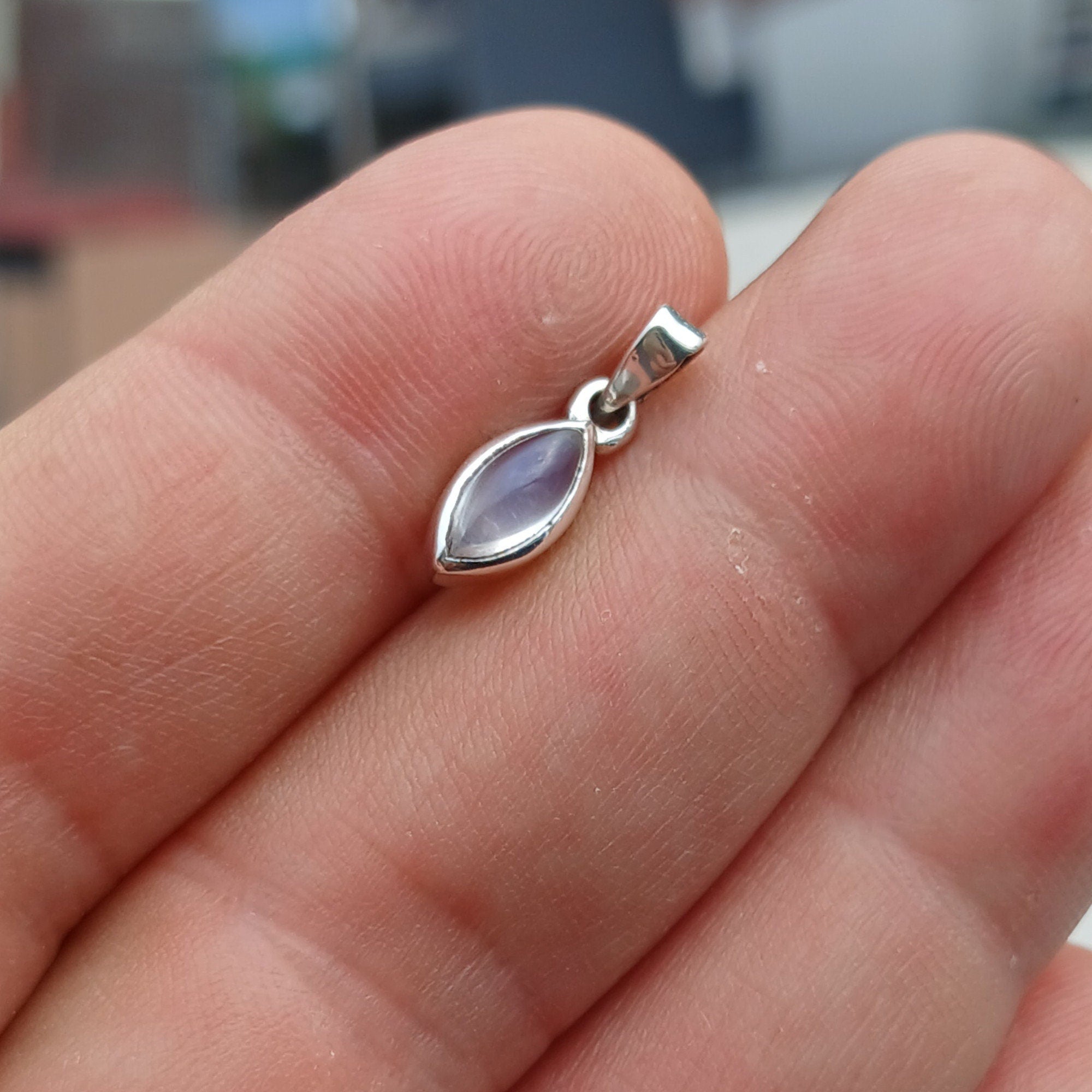 A beautiful Moonstone Pendant made of sterling silver, featuring a captivating Moonstone at its center, elegantly designed for versatile wear.