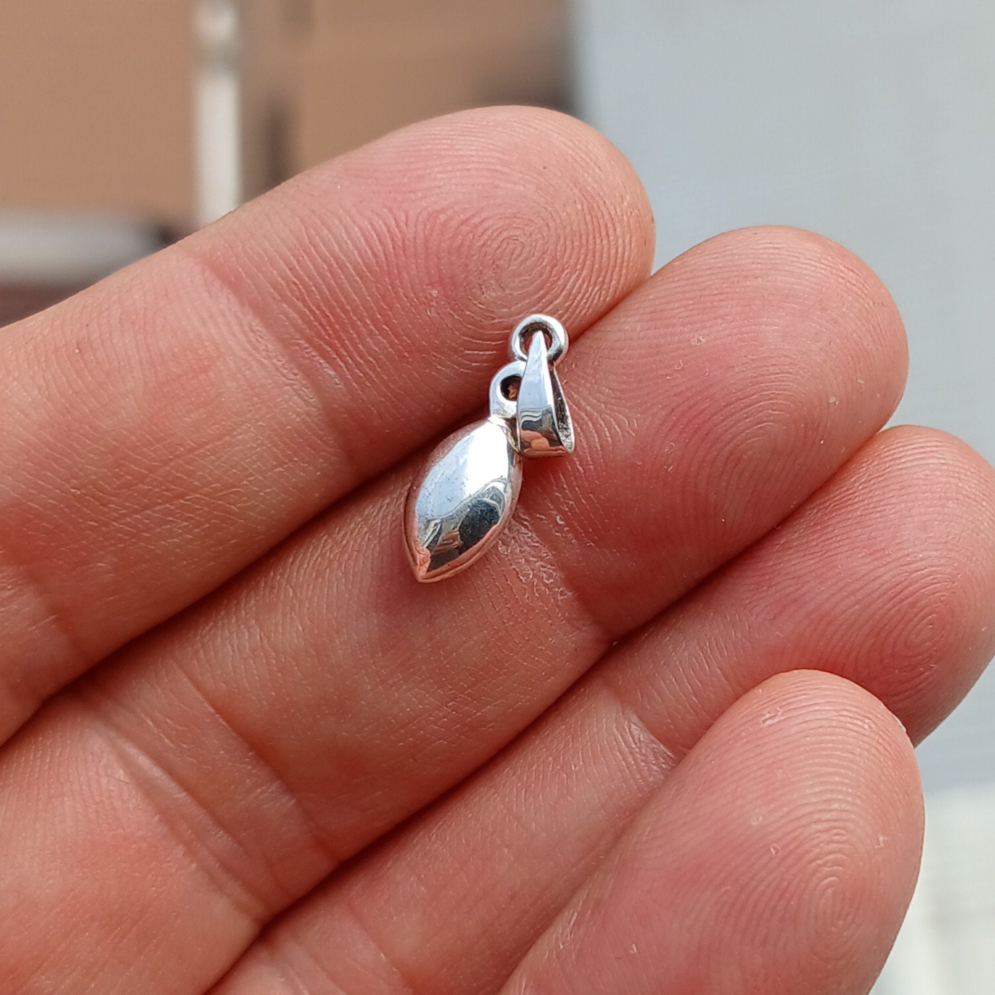 A stunning sterling silver Moonstone Pendant featuring a Ceylon Moonstone and CZ, showcasing its iridescent beauty.