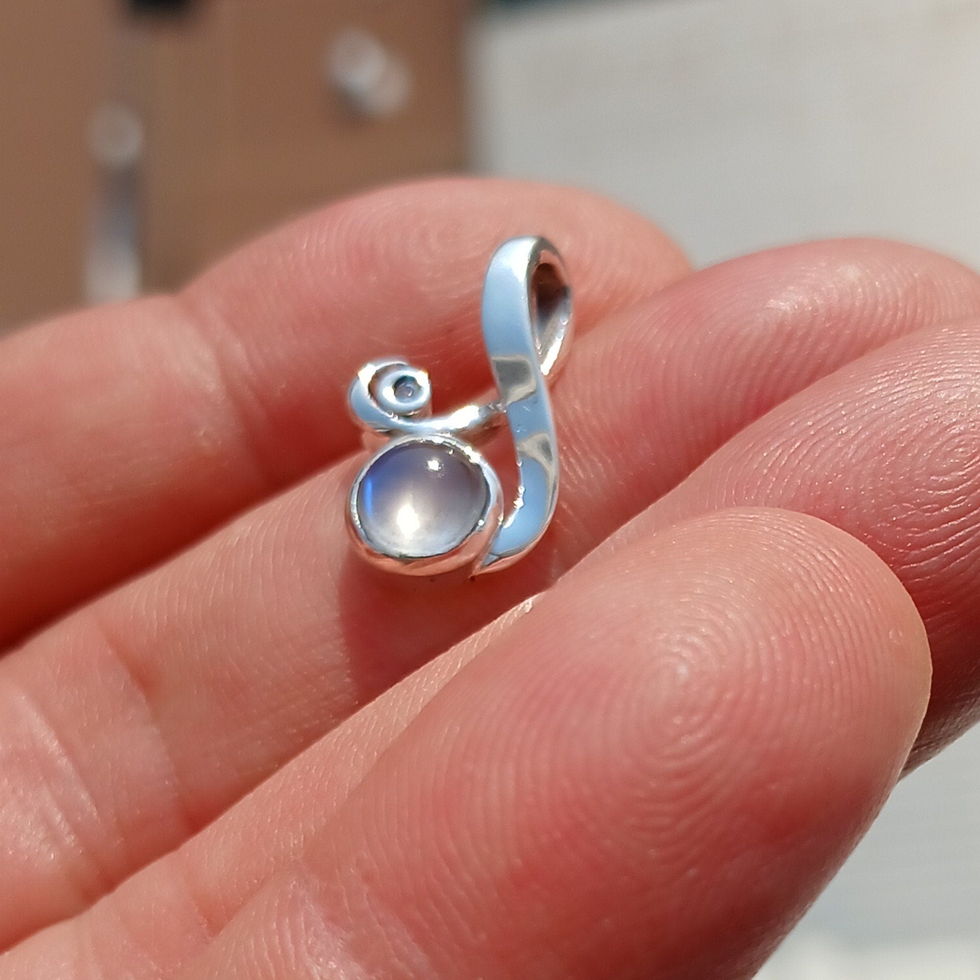 Elegant Moonstone Pendant featuring a Ceylon Moonstone in a minimalist sterling silver design with cubic zirconia.