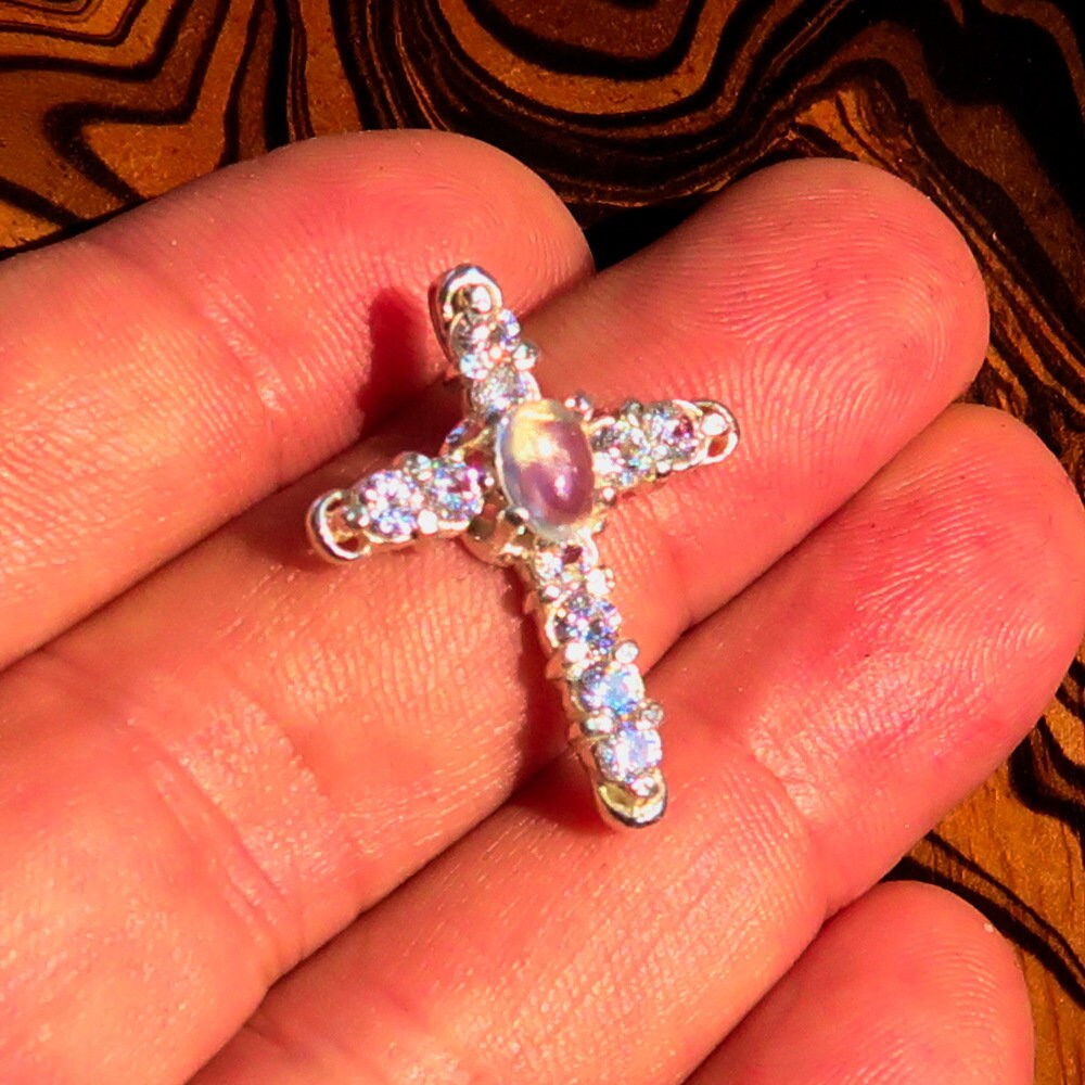 Elegant Moonstone Pendant featuring a Sterling Silver Cross design with Cubic Zirconia accents, showcasing a beautiful oval Ceylon Moonstone.