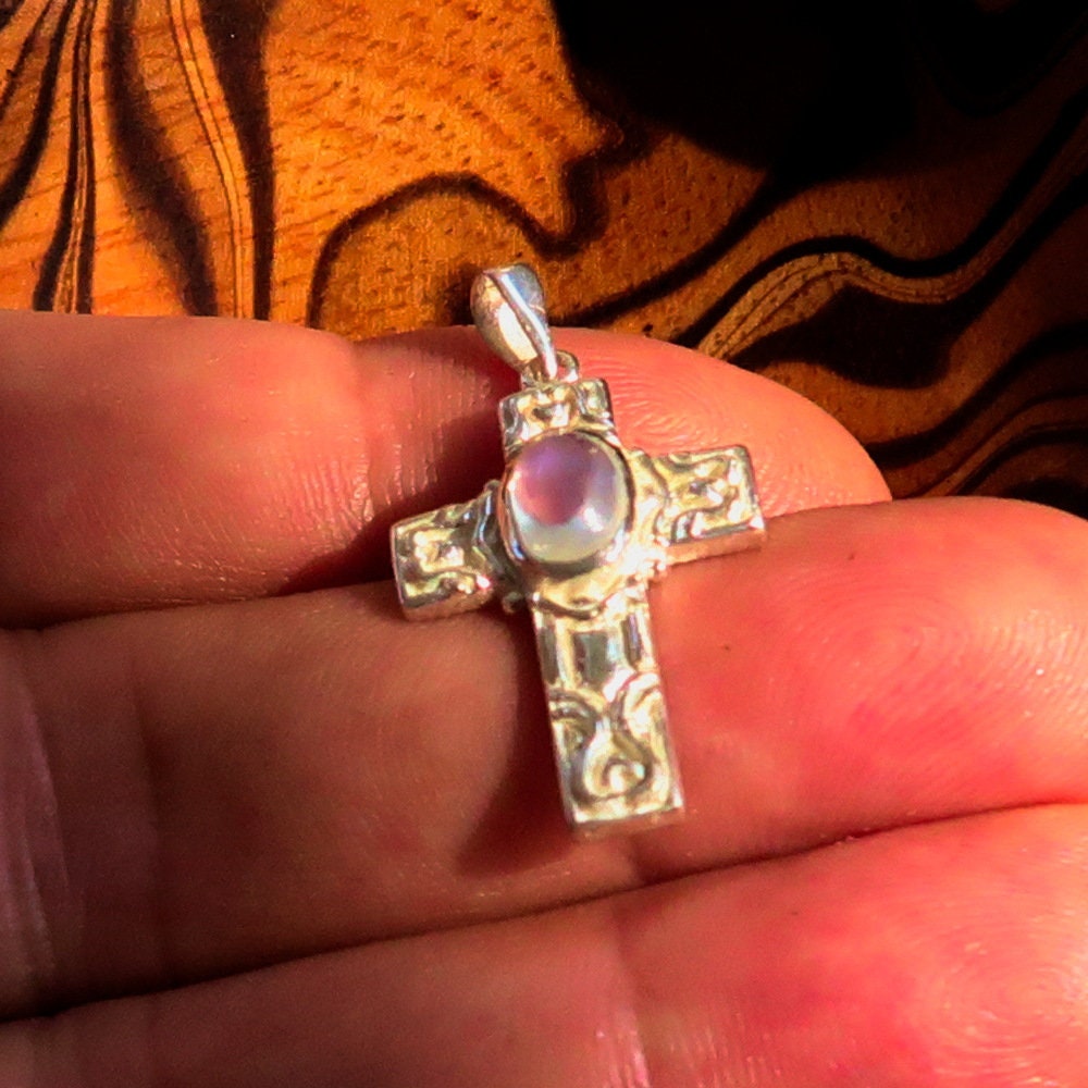 Sterling silver Moonstone pendant featuring a Celtic cross design, showcasing the moonstone's iridescent glow.