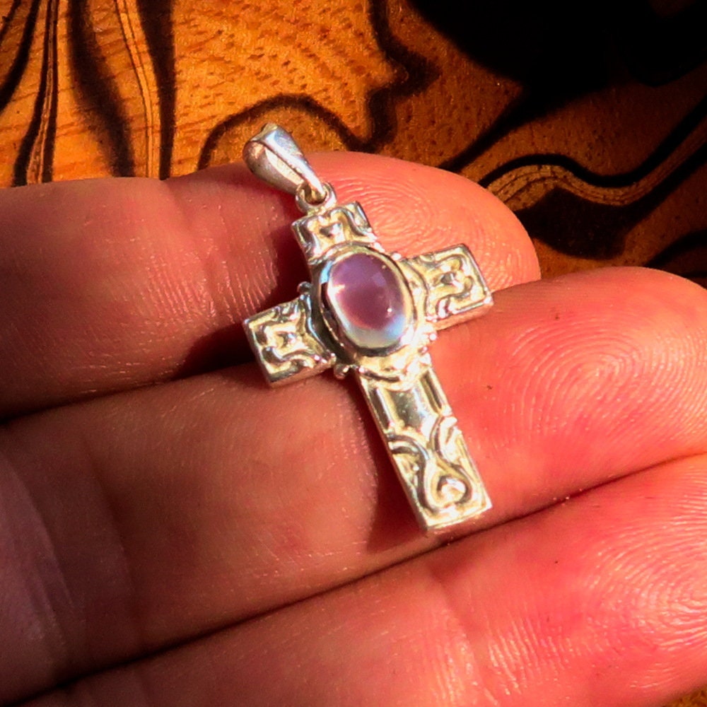 Sterling silver Moonstone pendant featuring a Celtic cross design, showcasing the moonstone's iridescent glow.