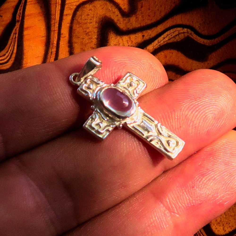 Sterling silver Moonstone pendant featuring a Celtic cross design, showcasing the moonstone's iridescent glow.