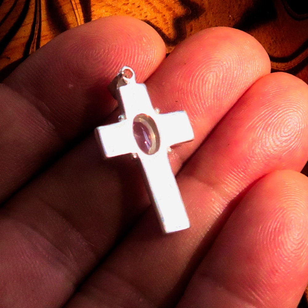 Sterling silver Moonstone pendant featuring a Celtic cross design, showcasing the moonstone's iridescent glow.