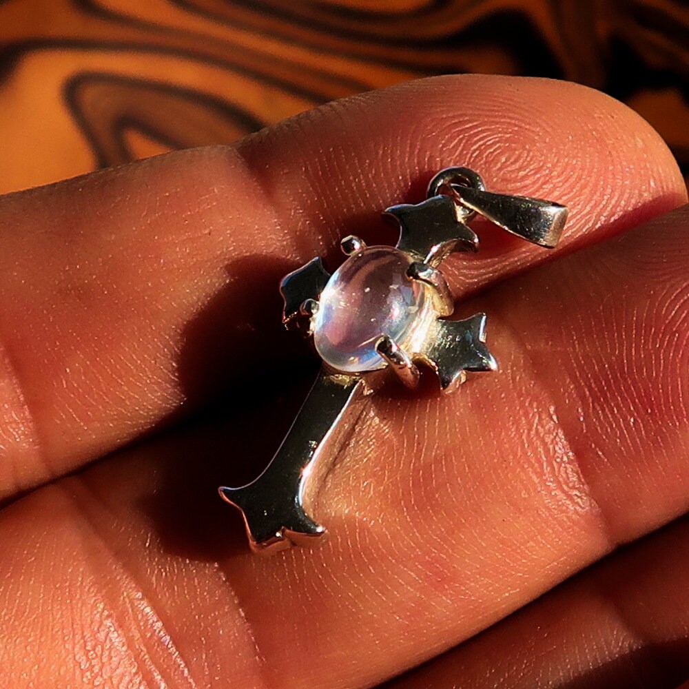 Elegant Moonstone Pendant in sterling silver featuring a cross design, showcasing an oval Ceylon Moonstone.
