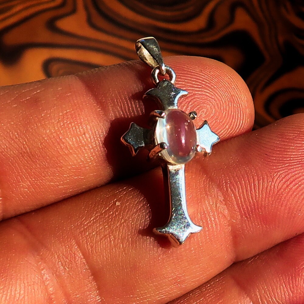 Elegant Moonstone Pendant in sterling silver featuring a cross design, showcasing an oval Ceylon Moonstone.