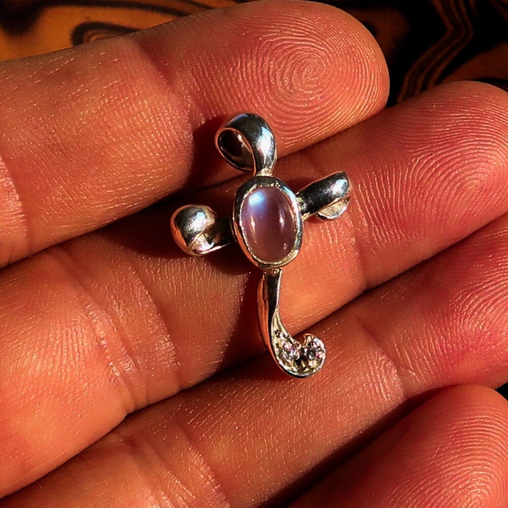Sterling silver cross pendant featuring a moonstone and cubic zirconia, elegantly designed with a 27 mm length and 18 mm width.
