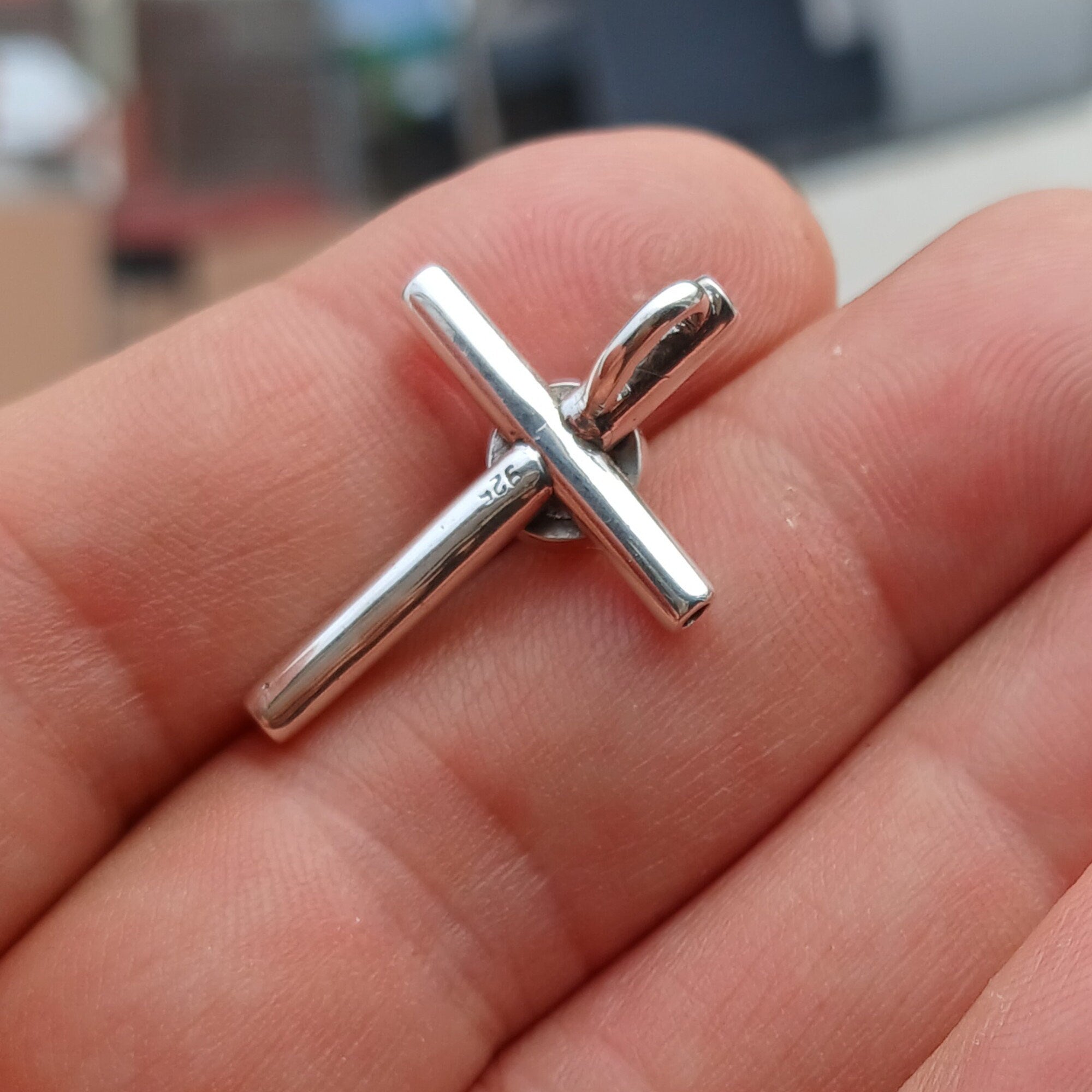 A beautiful Moonstone Pendant in sterling silver featuring a round Ceylon Moonstone at the center and a cross design, showcasing its elegant craftsmanship.