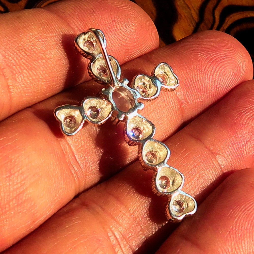 Elegant oval-shaped Moonstone Pendant in sterling silver with cubic zirconias, featuring a cross design.