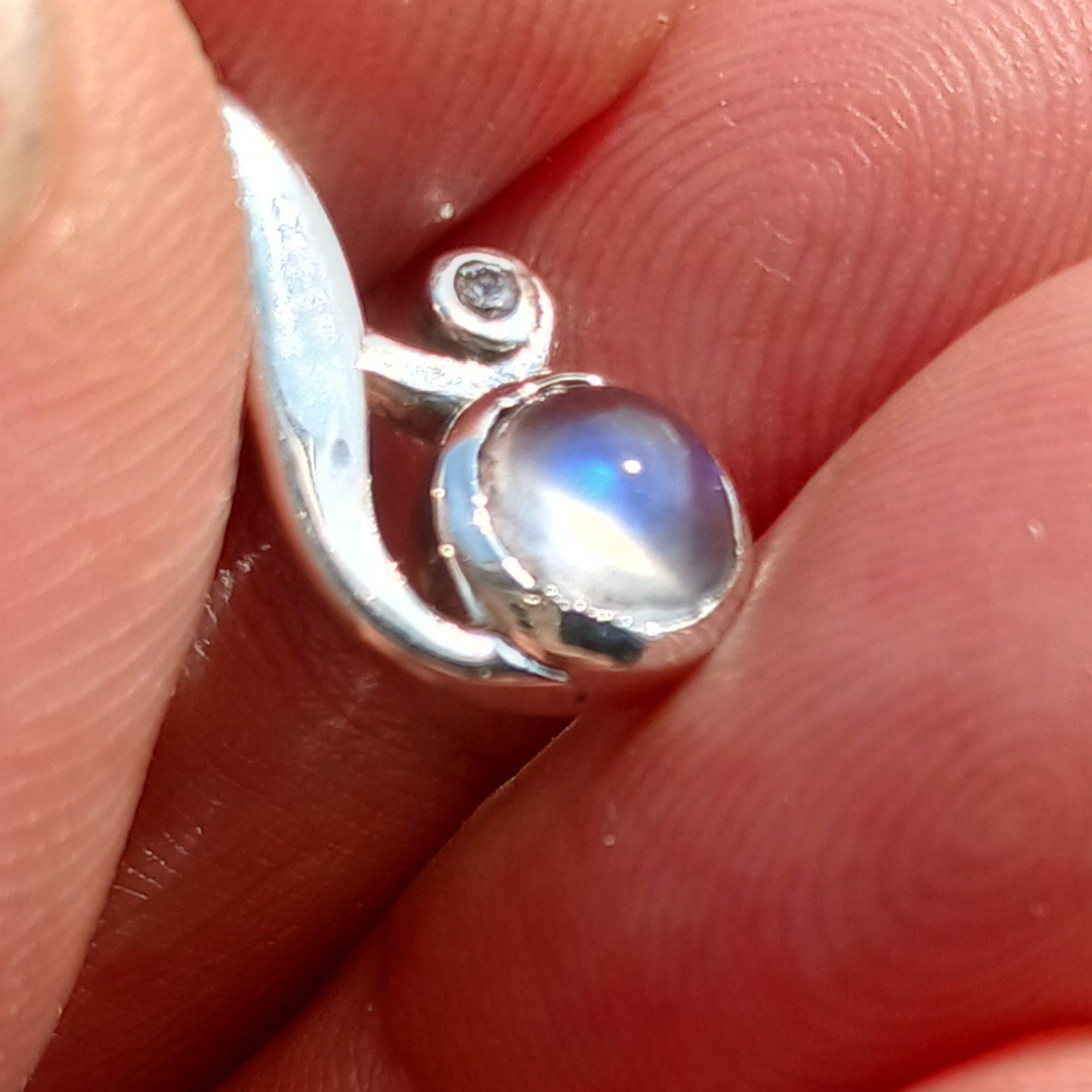 A beautiful sterling silver moonstone pendant featuring cubic zirconias, showcasing its elegant design and dimensions.