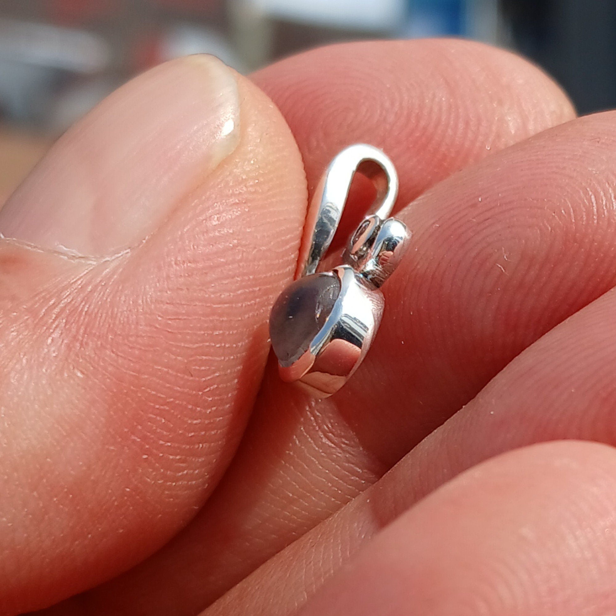 A beautiful sterling silver moonstone pendant featuring cubic zirconias, showcasing its elegant design and dimensions.