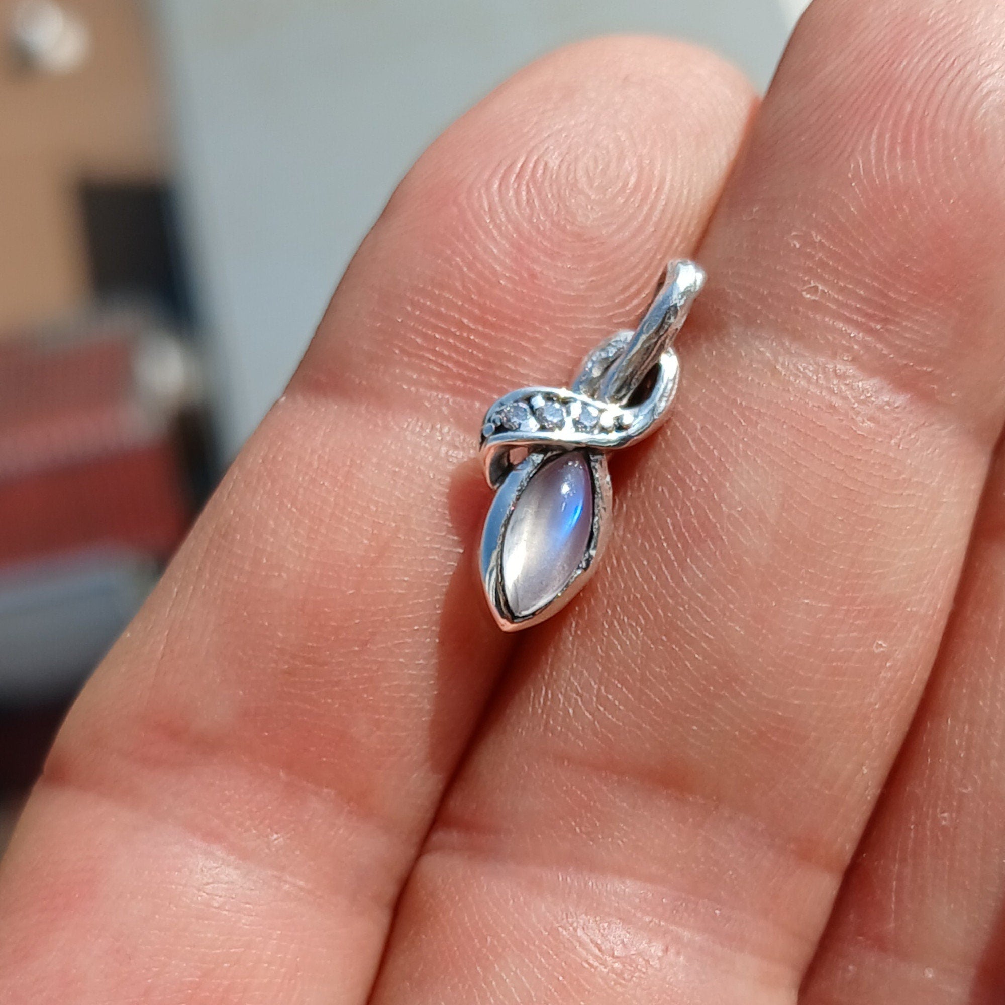 Elegant Moonstone Pendant in sterling silver with cubic zirconias, showcasing its natural beauty and craftsmanship.