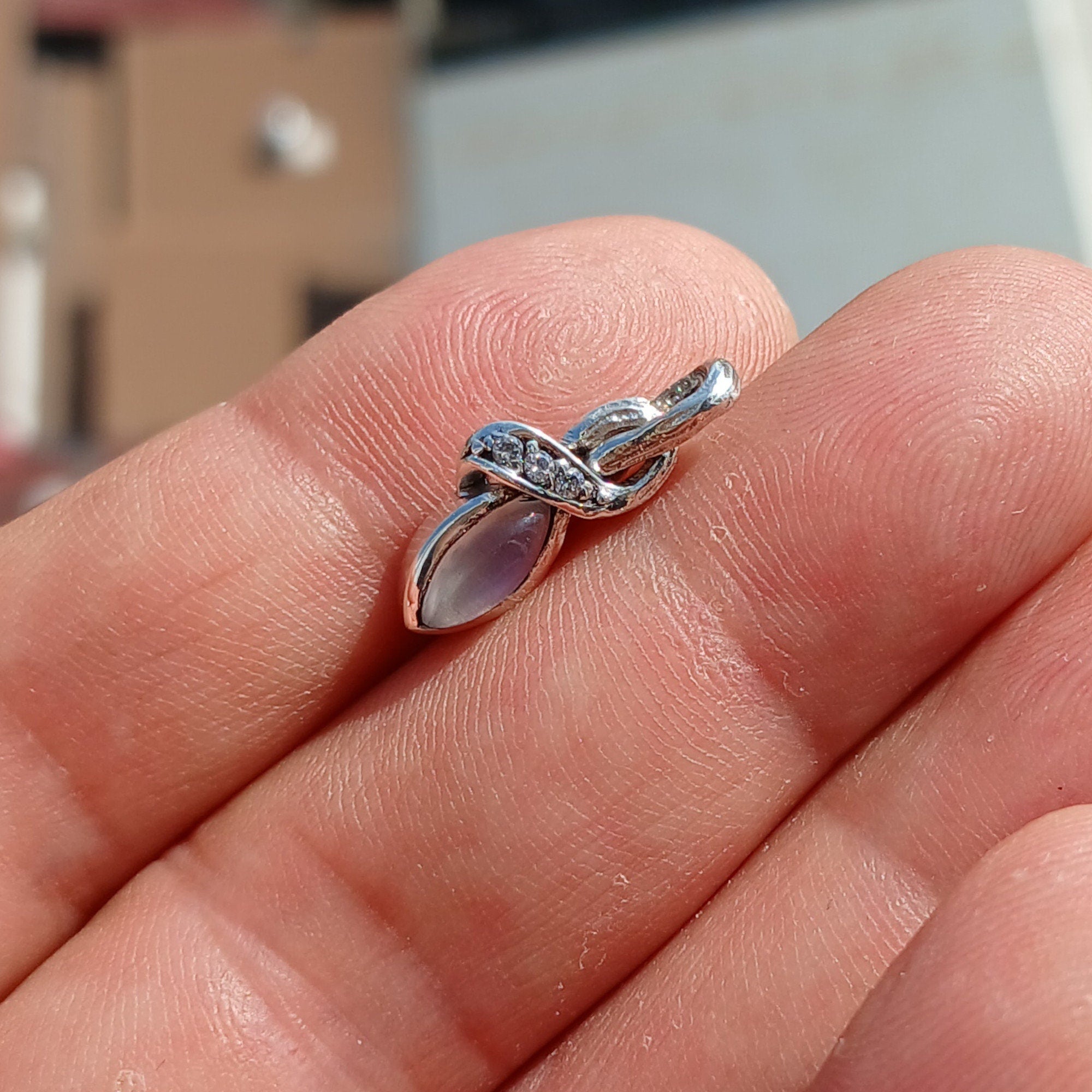 Elegant Moonstone Pendant in sterling silver with cubic zirconias, showcasing its natural beauty and craftsmanship.