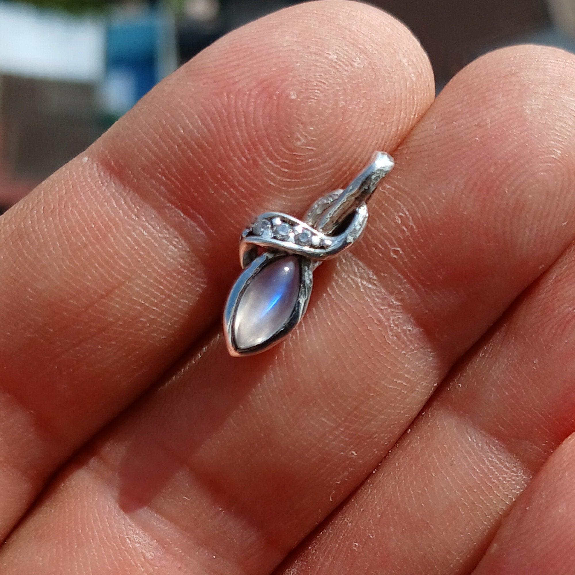Elegant Moonstone Pendant in sterling silver with cubic zirconias, showcasing its natural beauty and craftsmanship.