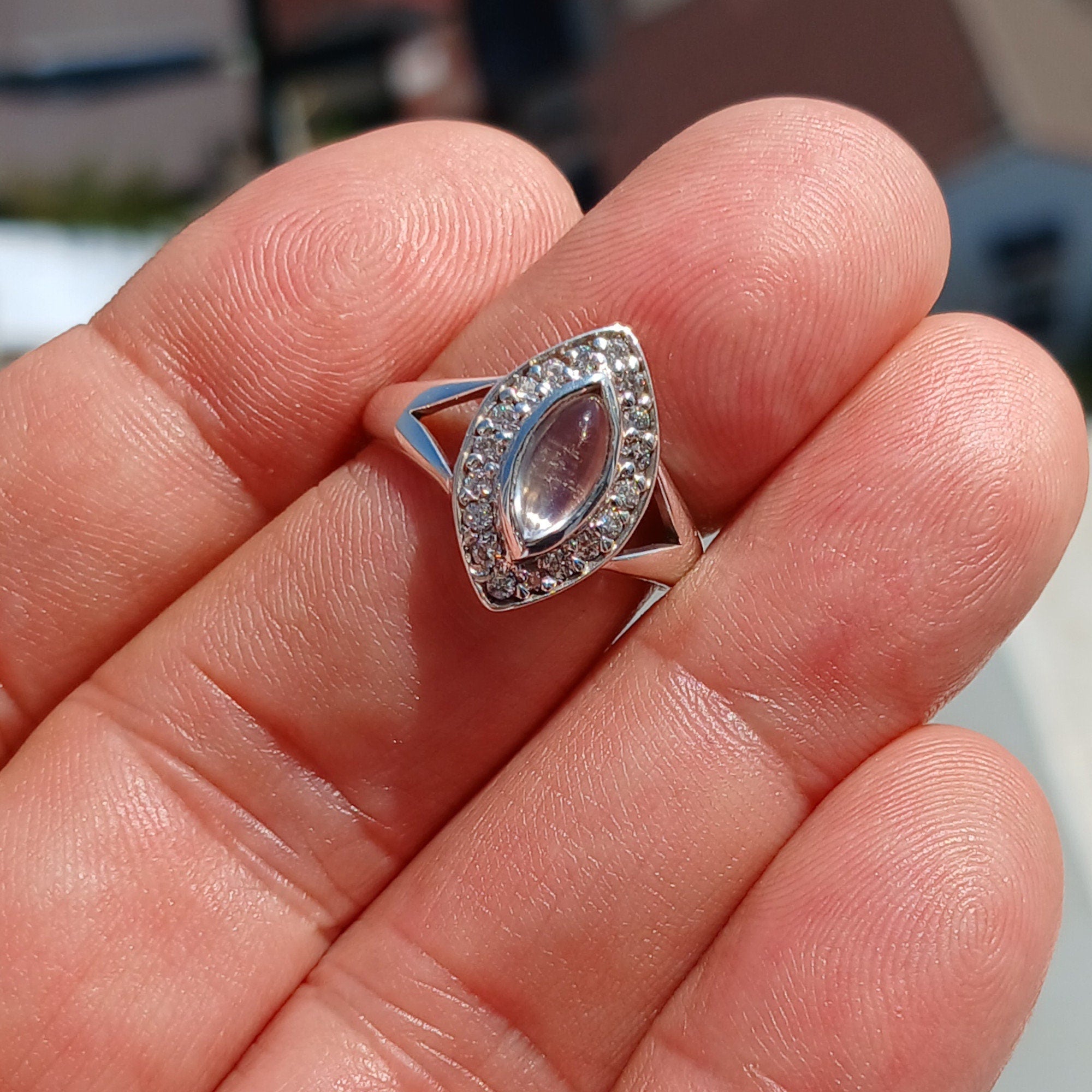 Elegant Moonstone Ring in sterling silver with marquise Ceylon Moonstone and 16 sparkling CZ stones, showcasing a sophisticated design.