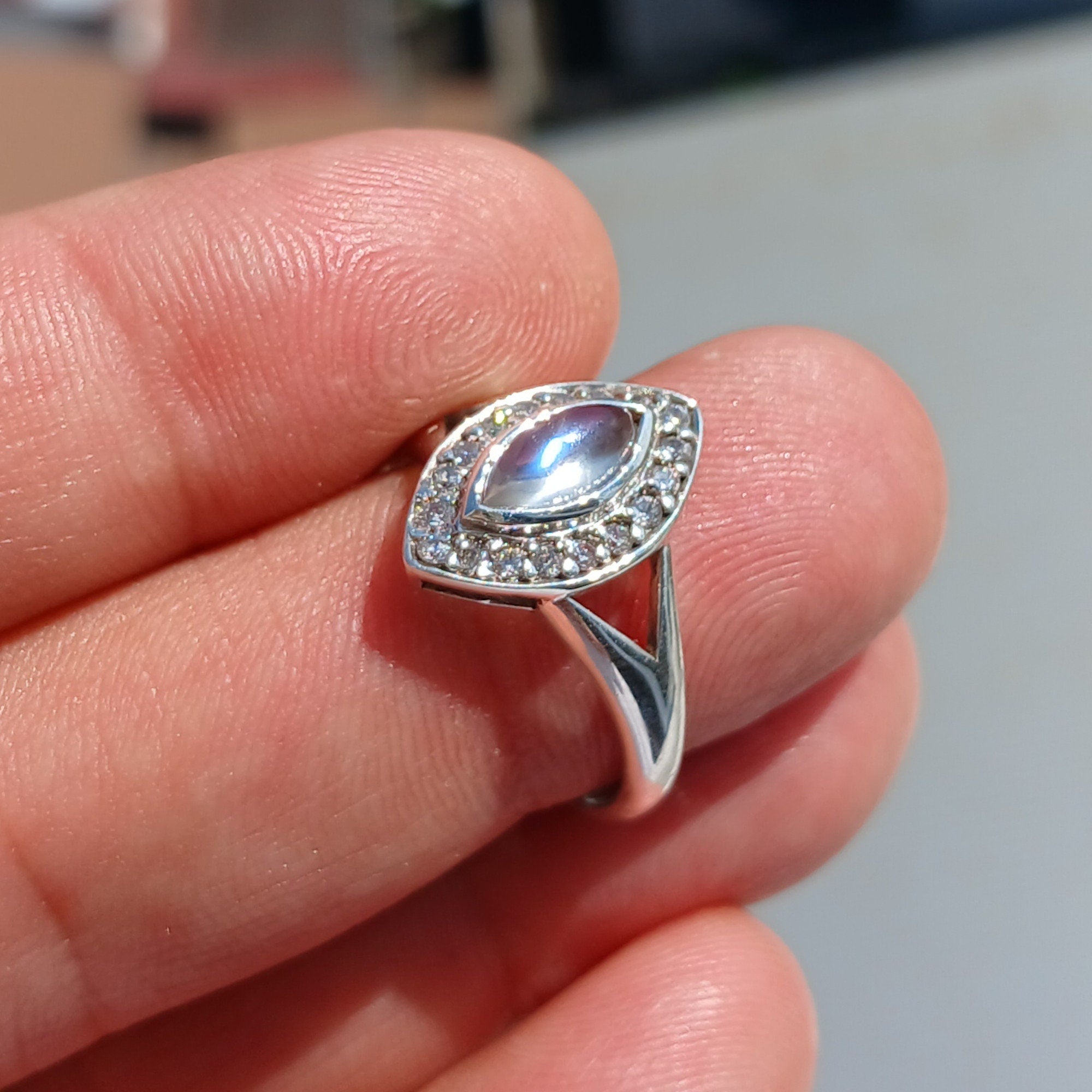 Elegant Moonstone Ring in sterling silver with marquise Ceylon Moonstone and 16 sparkling CZ stones, showcasing a sophisticated design.