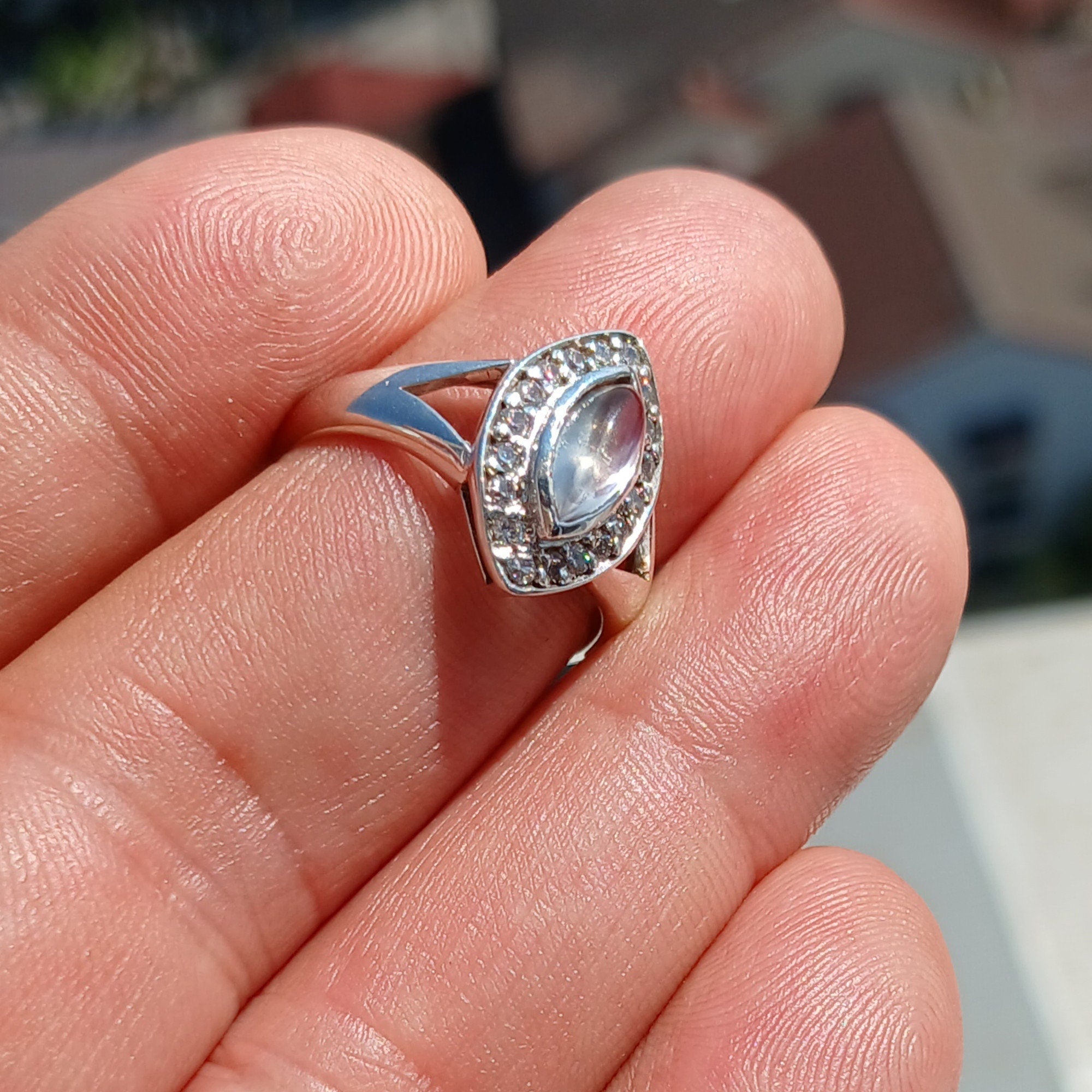 Elegant Moonstone Ring in sterling silver with marquise Ceylon Moonstone and 16 sparkling CZ stones, showcasing a sophisticated design.