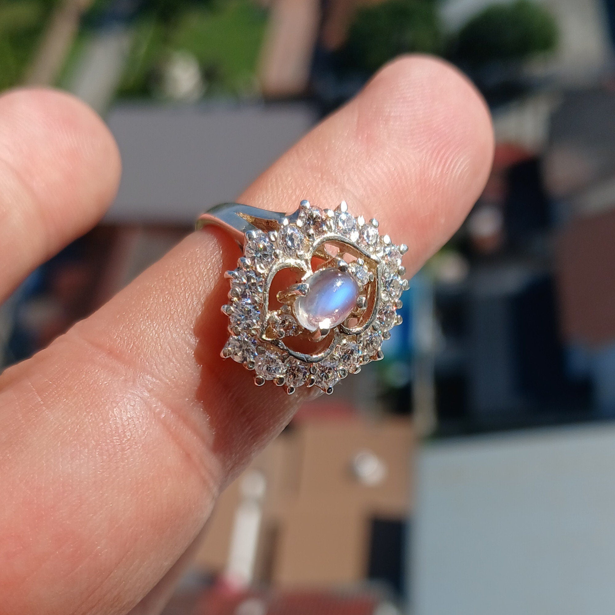 A polished sterling silver ring featuring an oval moonstone, showcasing its elegant design and hallmarked 925 authenticity.