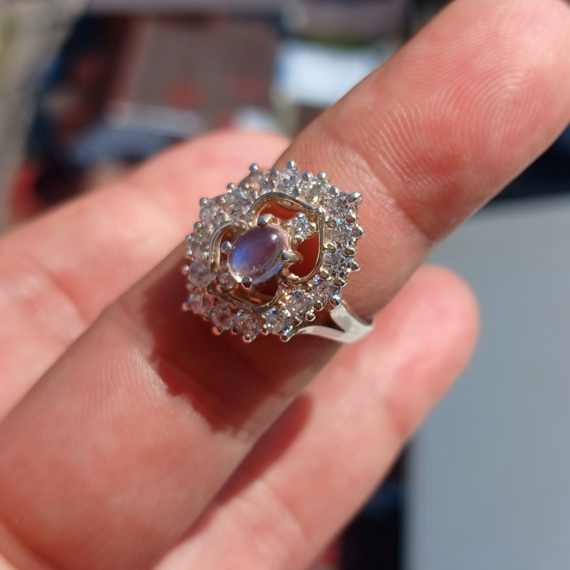 A polished sterling silver ring featuring an oval moonstone, showcasing its elegant design and hallmarked 925 authenticity.