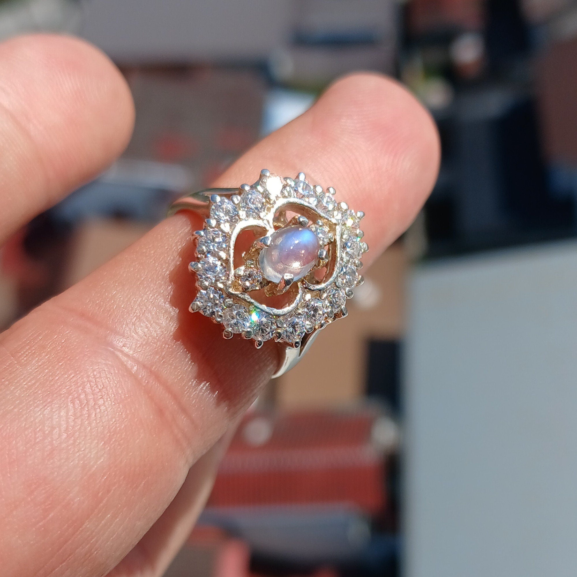 A polished sterling silver ring featuring an oval moonstone, showcasing its elegant design and hallmarked 925 authenticity.