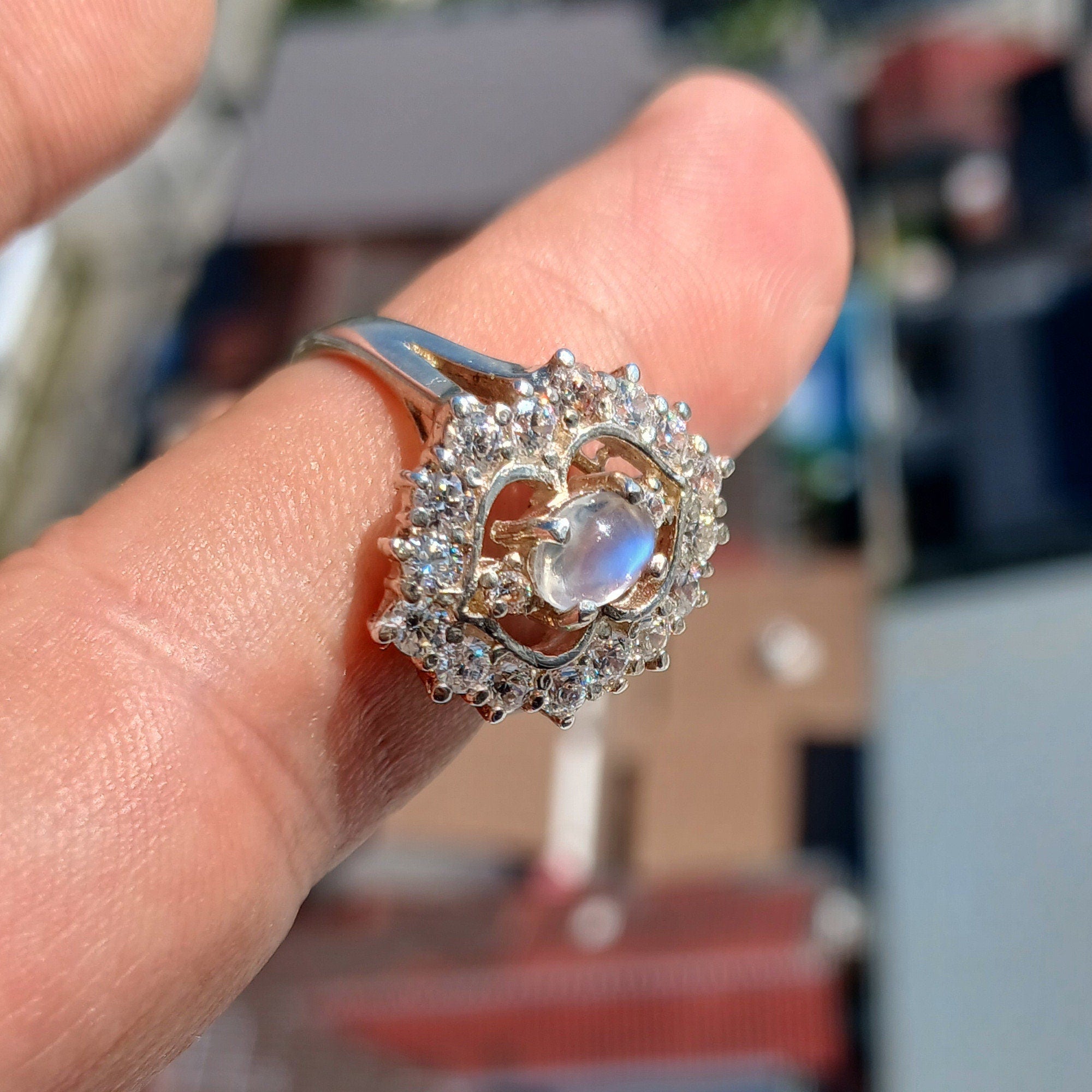 A polished sterling silver ring featuring an oval moonstone, showcasing its elegant design and hallmarked 925 authenticity.