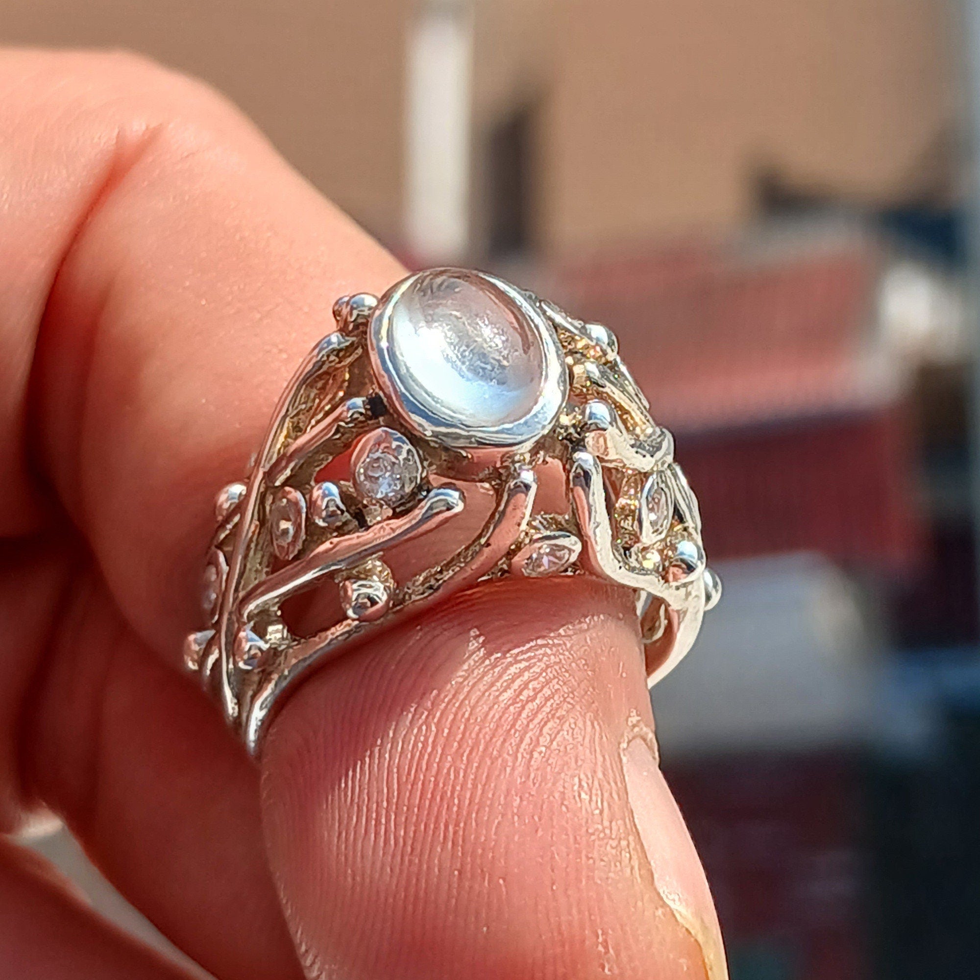 A polished sterling silver ring featuring an oval moonstone, showcasing its elegant design and high-quality craftsmanship.