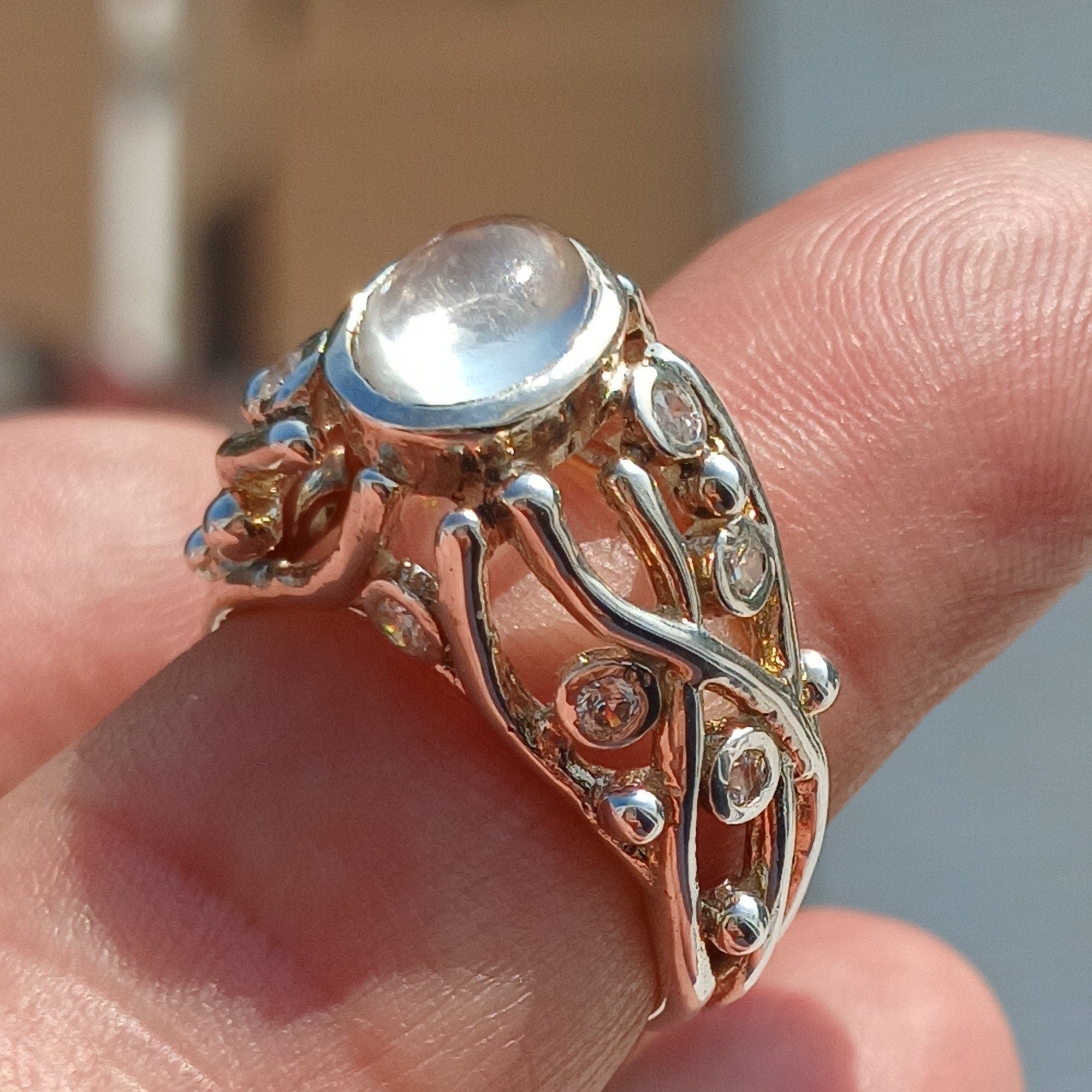 A polished sterling silver ring featuring an oval moonstone, showcasing its elegant design and high-quality craftsmanship.