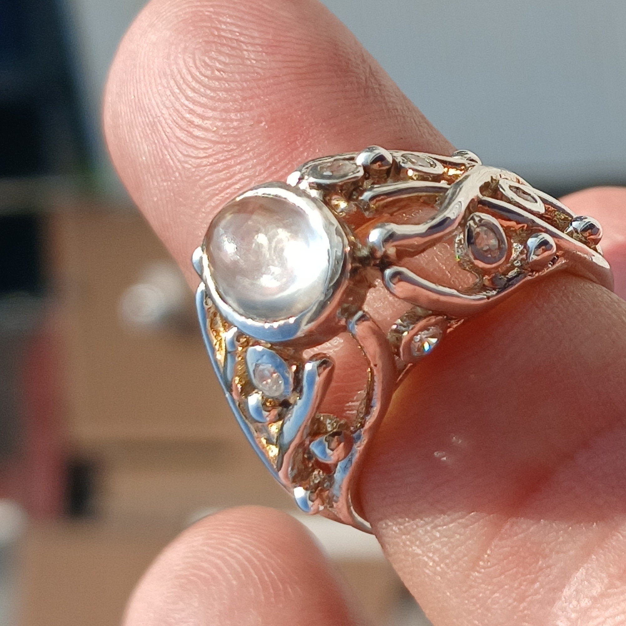 A polished sterling silver ring featuring an oval moonstone, showcasing its elegant design and high-quality craftsmanship.