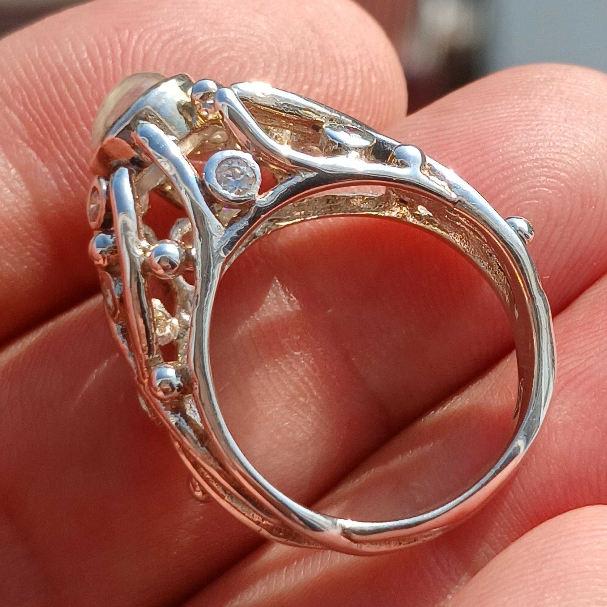 A polished sterling silver ring featuring an oval moonstone, showcasing its elegant design and high-quality craftsmanship.